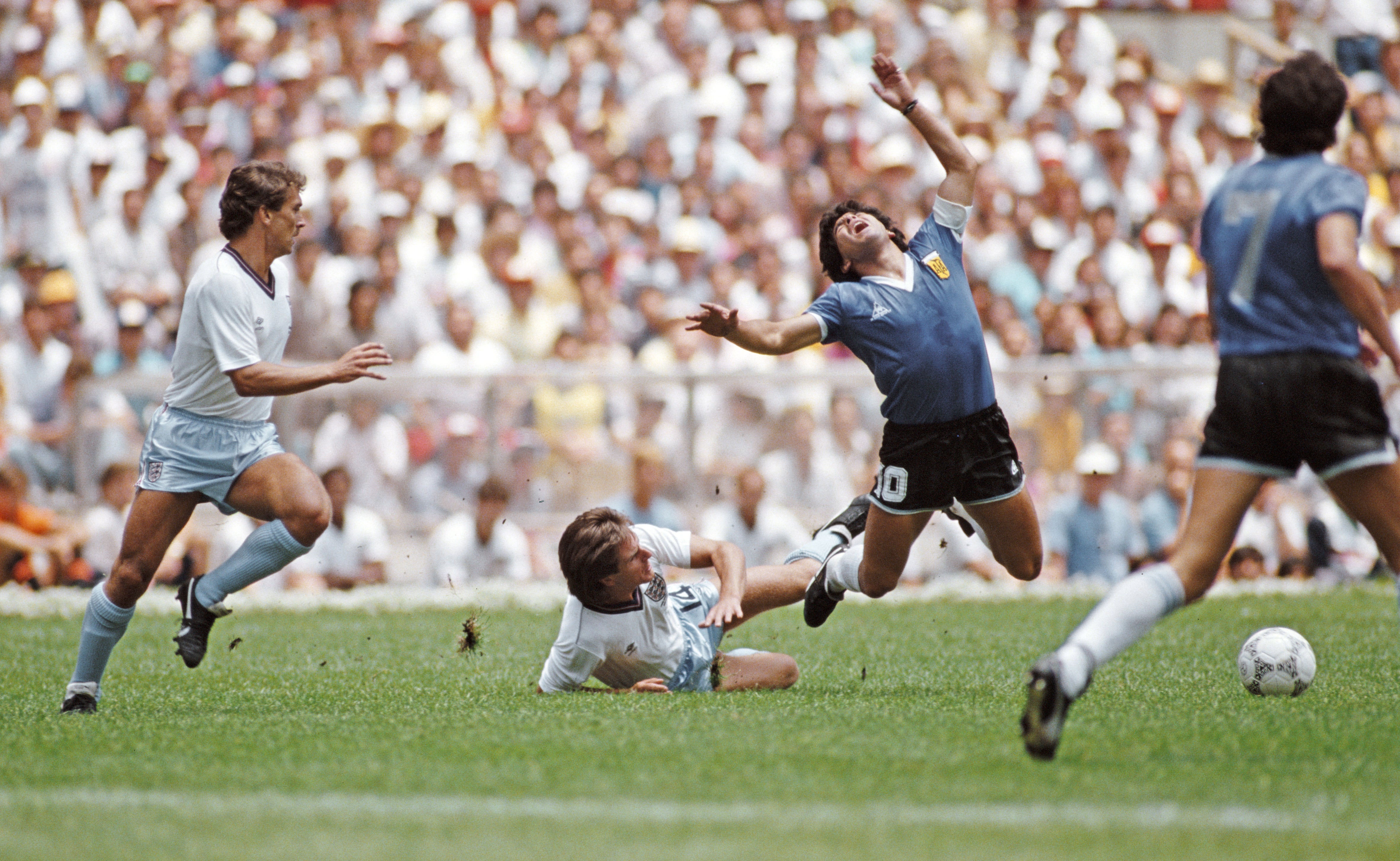 Argentina player Diego Maradona is challenged by England player Terry Fenwick during the FIFA 1986 World Cup quarter-finals
