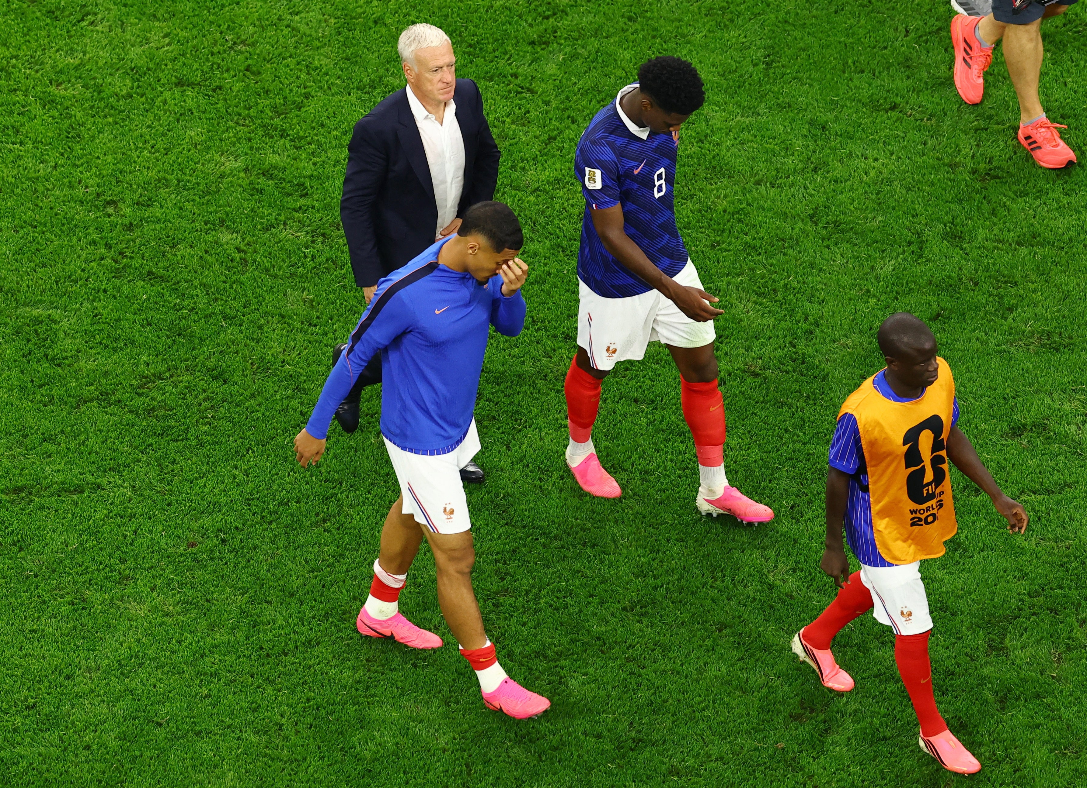 France’s William Saliba, Aurelien Tchouameni, and coach Deschamps look dejected after the match