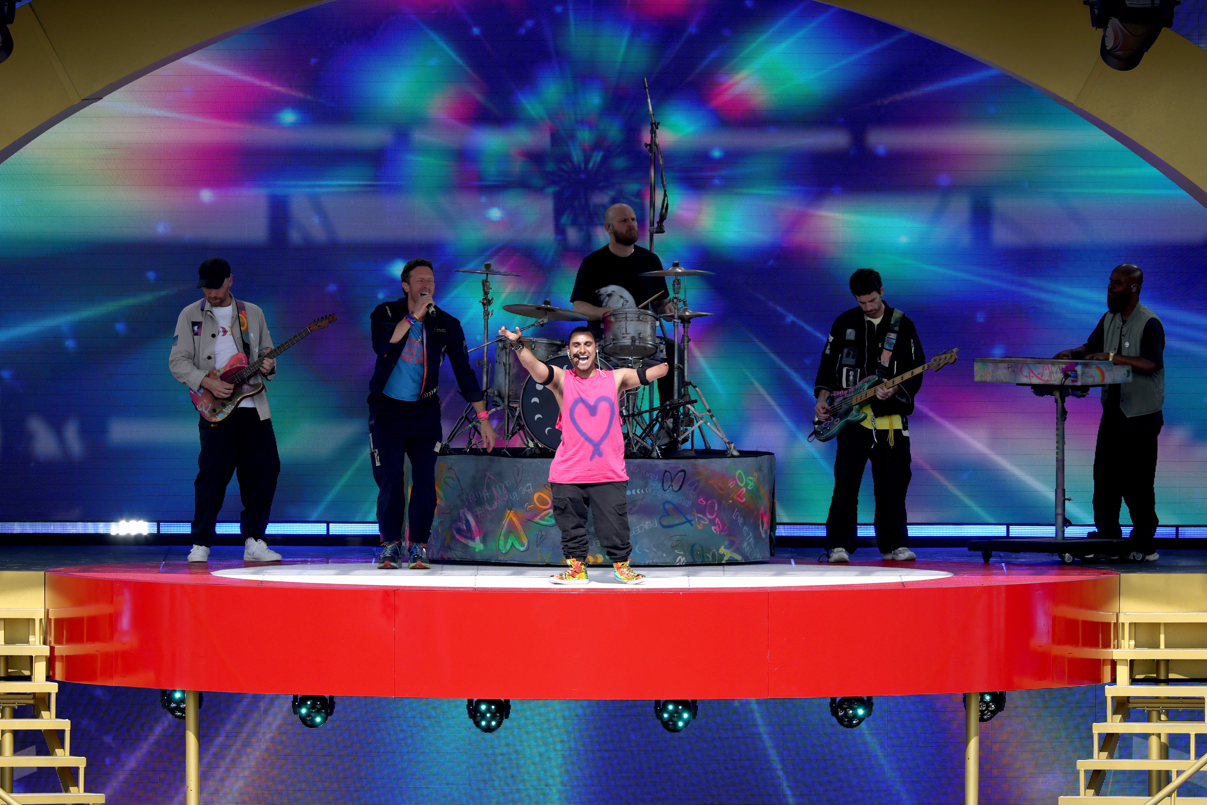 Chris Martin of Coldplay and Emmanuel Kelly perform during the halftime show during the FIFA Club World Cup 2025 Final match between Chelsea FC and Paris Saint-Germain