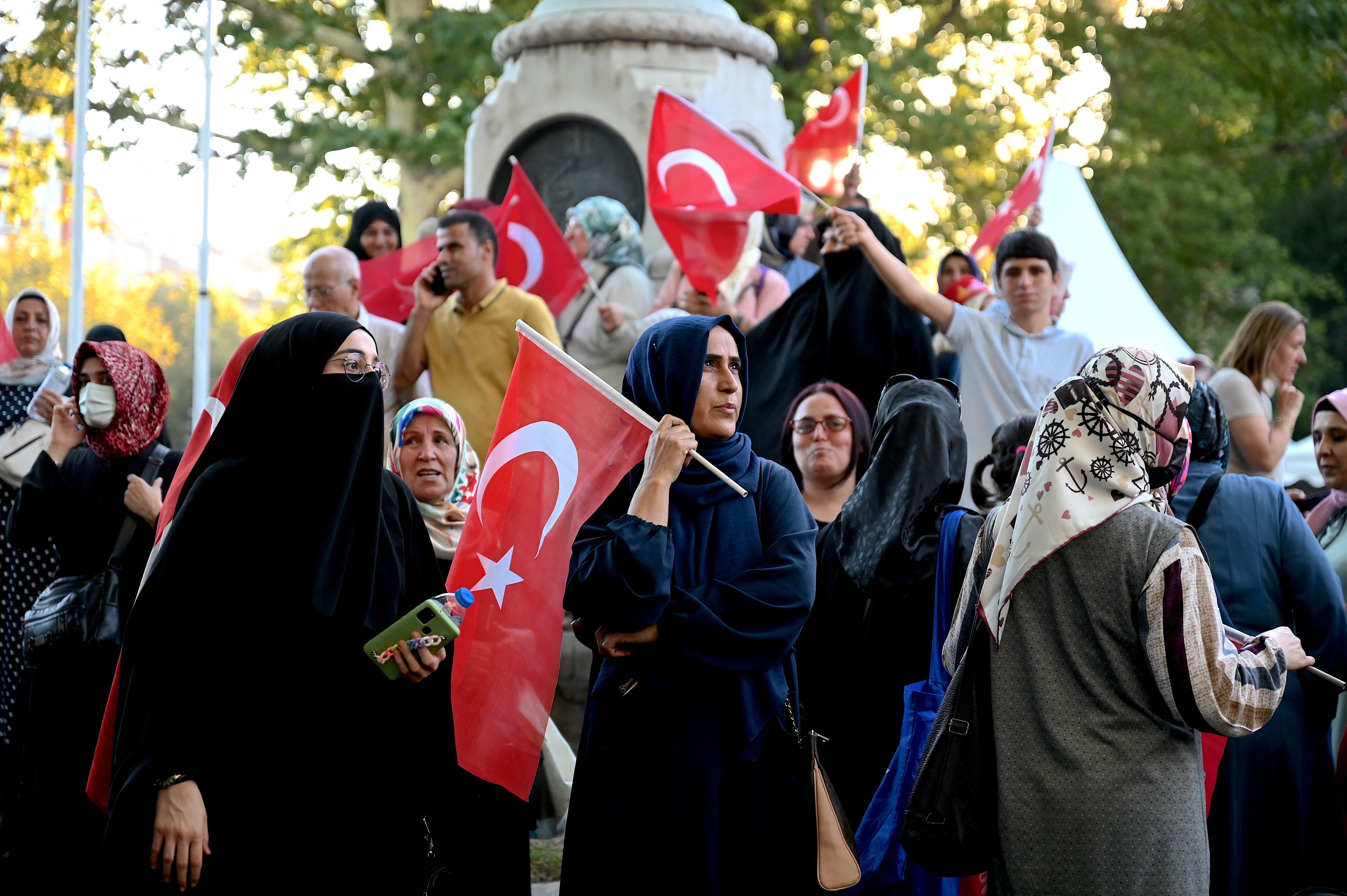 Supporters wave Turkish flags during Erdogan's speech in Fatih, Istanbul on July 15, 2022, commemorating the 2016 failed coup