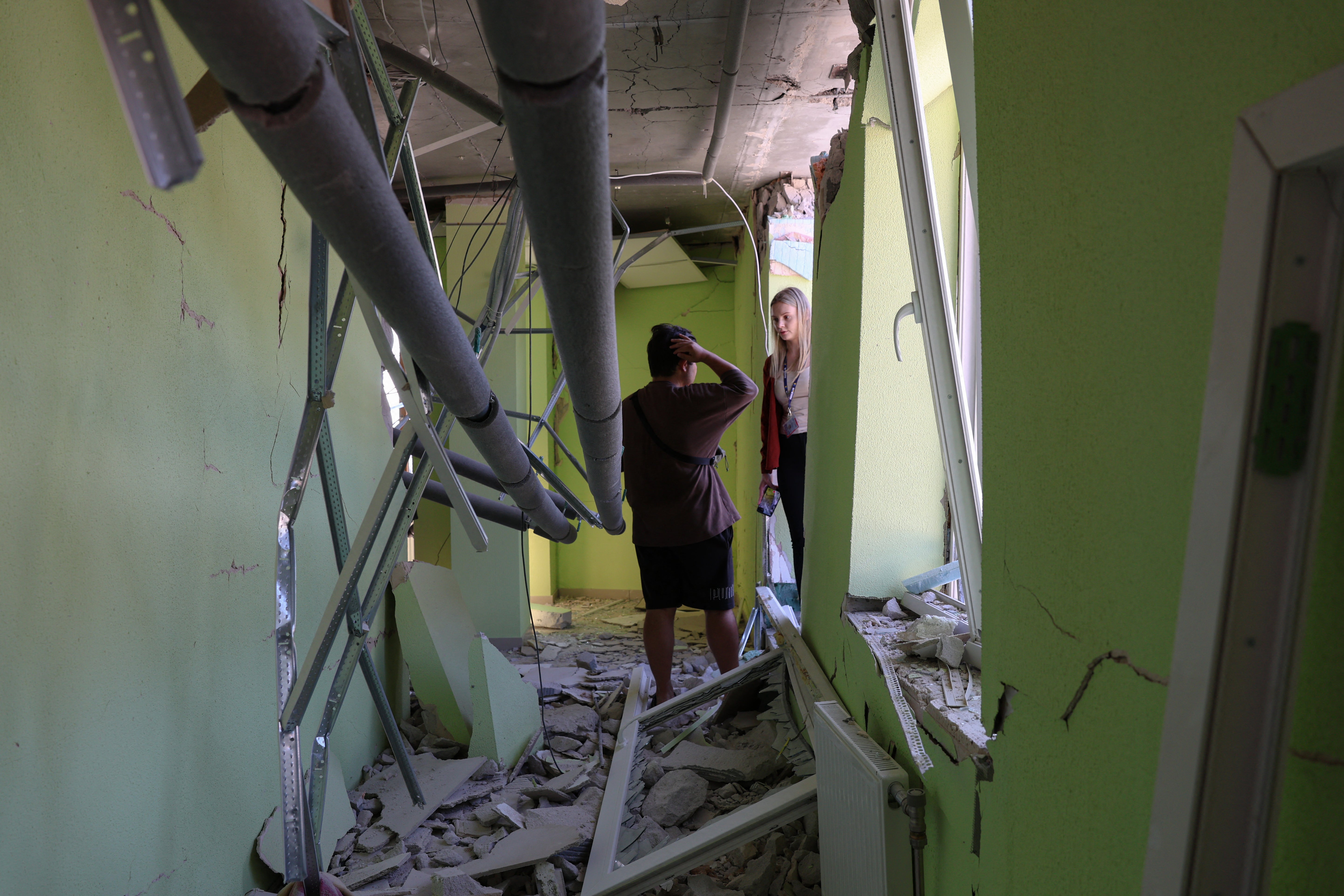 People stand in a hallway of a damaged residential building following a Russian strike in Odesa on July 15 (AFP/Getty)