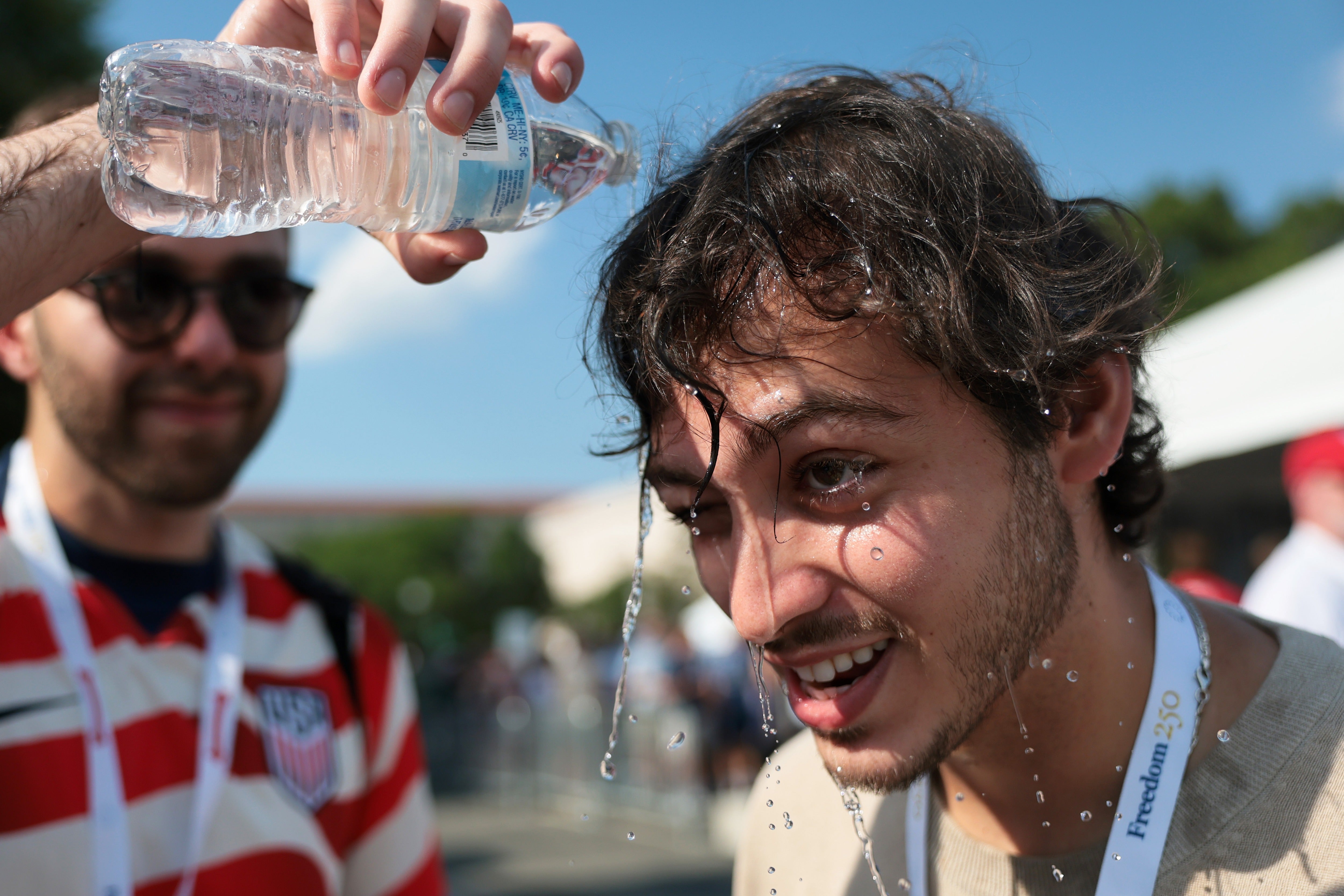 This week’s heat advisories come after a record-breaking heat wave scorched large stretches of the country earlier this month. Pictured: a man tries to cool off on the National Mall in Washington, DC on July 4