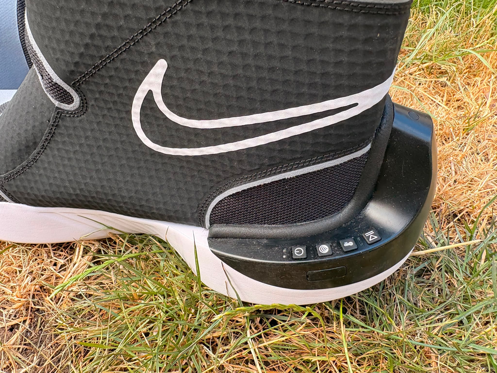 Buttons on the side of the Nike x Hyperice hyperboot control the pressure and temperature (Harry Bullmore/The Independent)