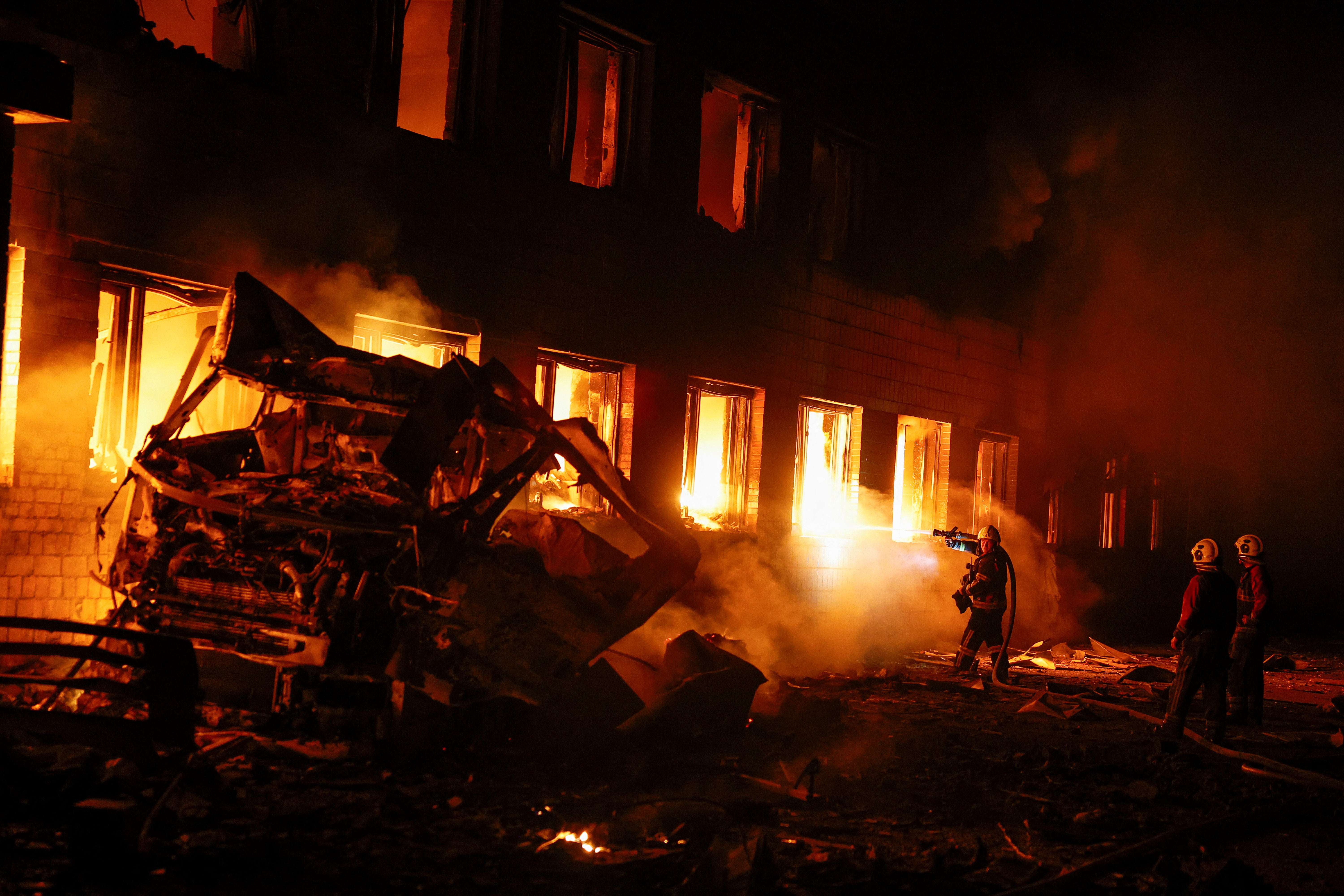 Firefighters work at a compound of a private enterprise damaged during Russian missile strikes, amid Russia's attack on Ukraine, in Kyiv (Reuters)