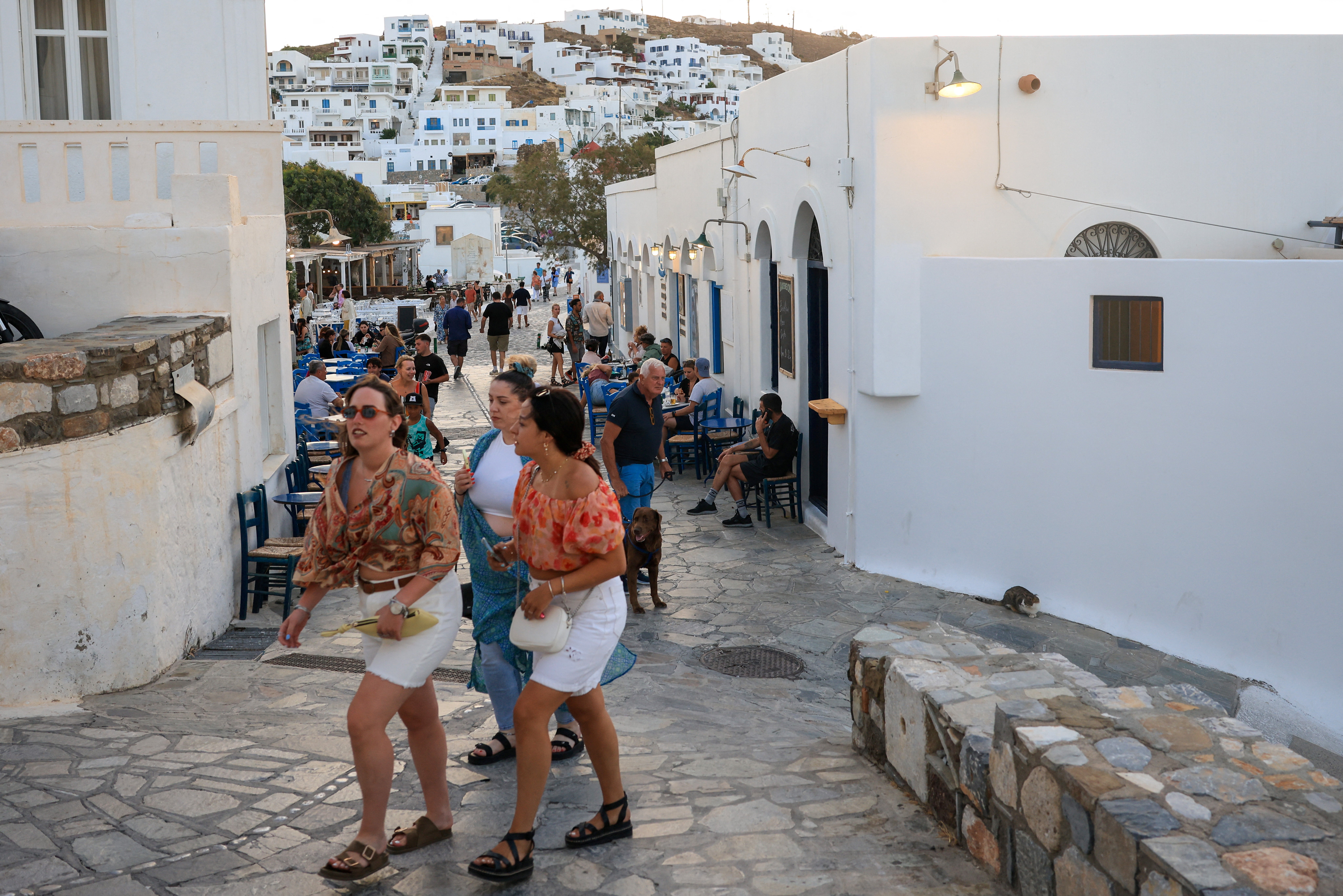 Tourists walk in the main town on the island, which declared a drought emergency, in Astypalaia, Greece, July 13, 2026