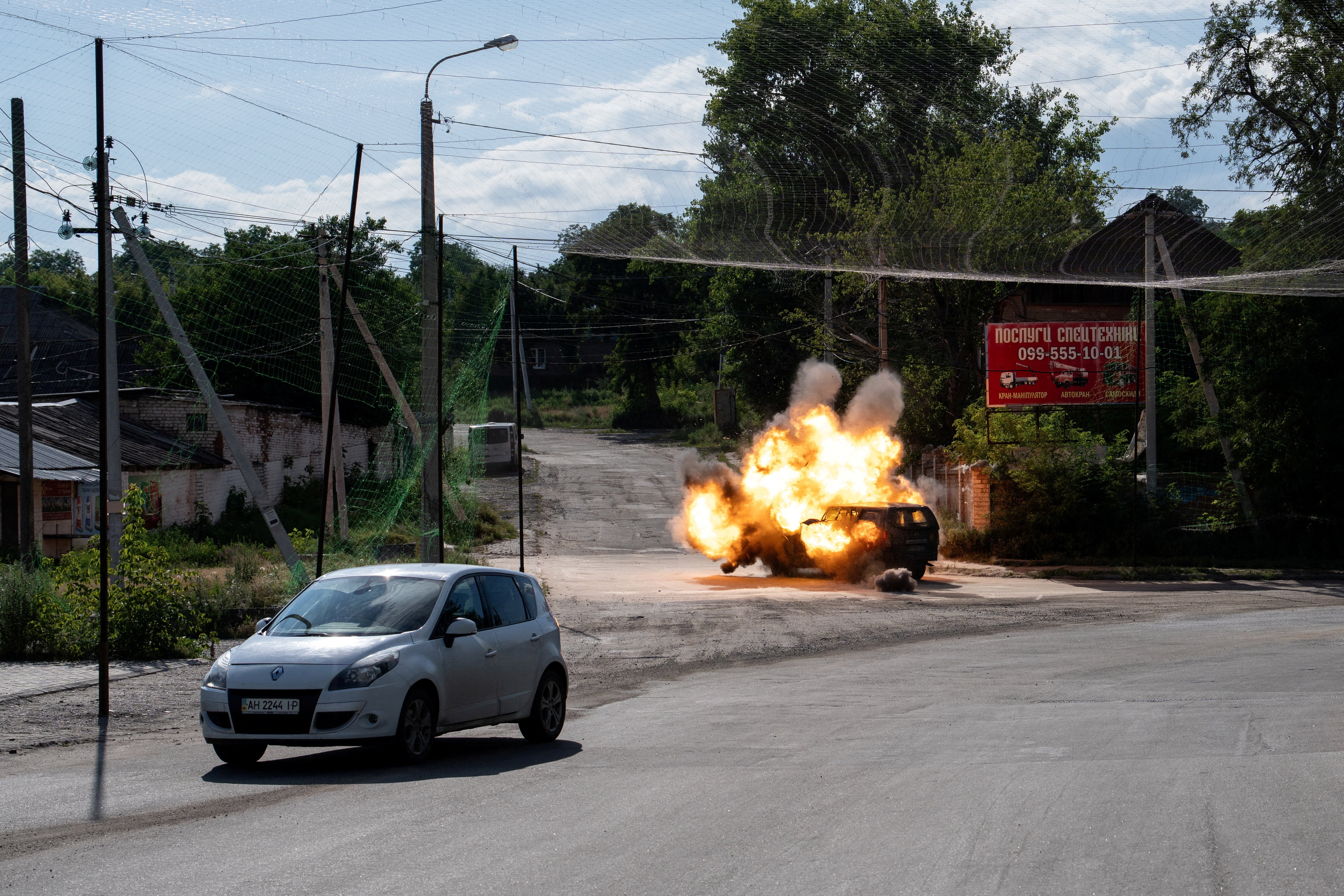 A Russian FPV-drone hits a car, amid Russia's attack on Ukraine, in the frontline town of Kramatorsk. The recruitment of troops to become skilled drone operators is now critical for Russia and Ukraine
