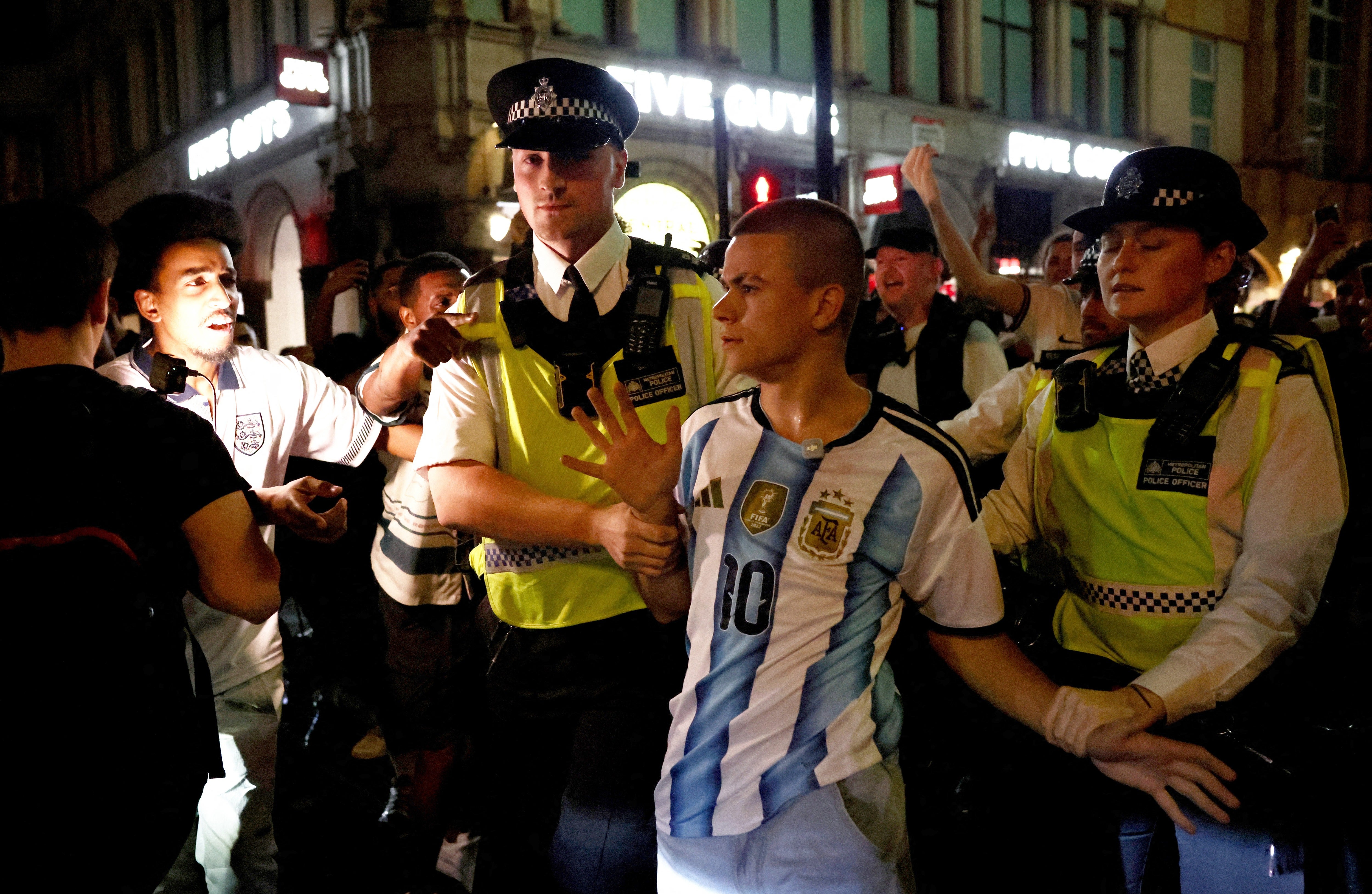 Argentina fan swarmed by England supporters in central London rescued by police