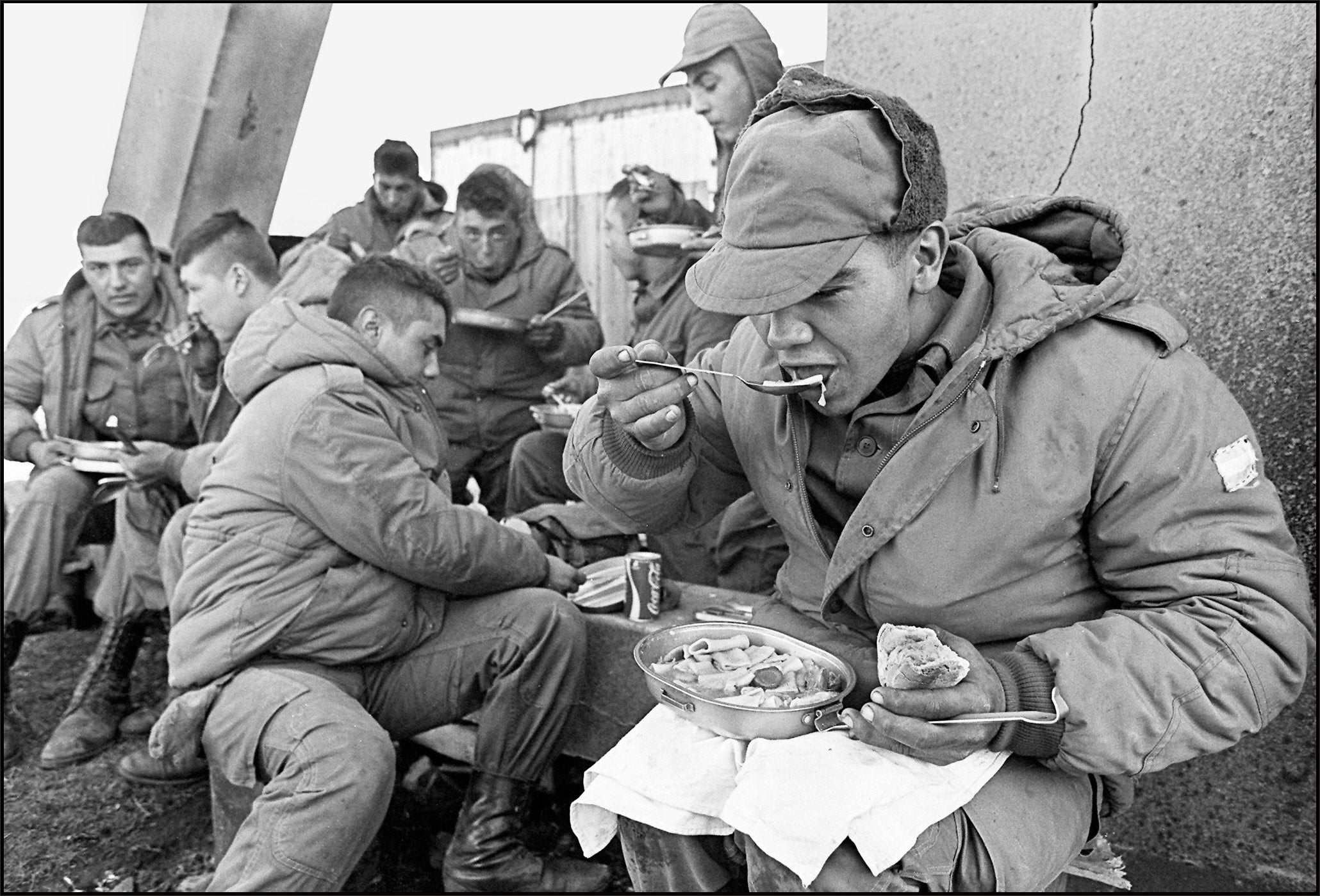 Argentine soldiers have lunch at the partially destroyed former Royal Marines base, 13 April 1982