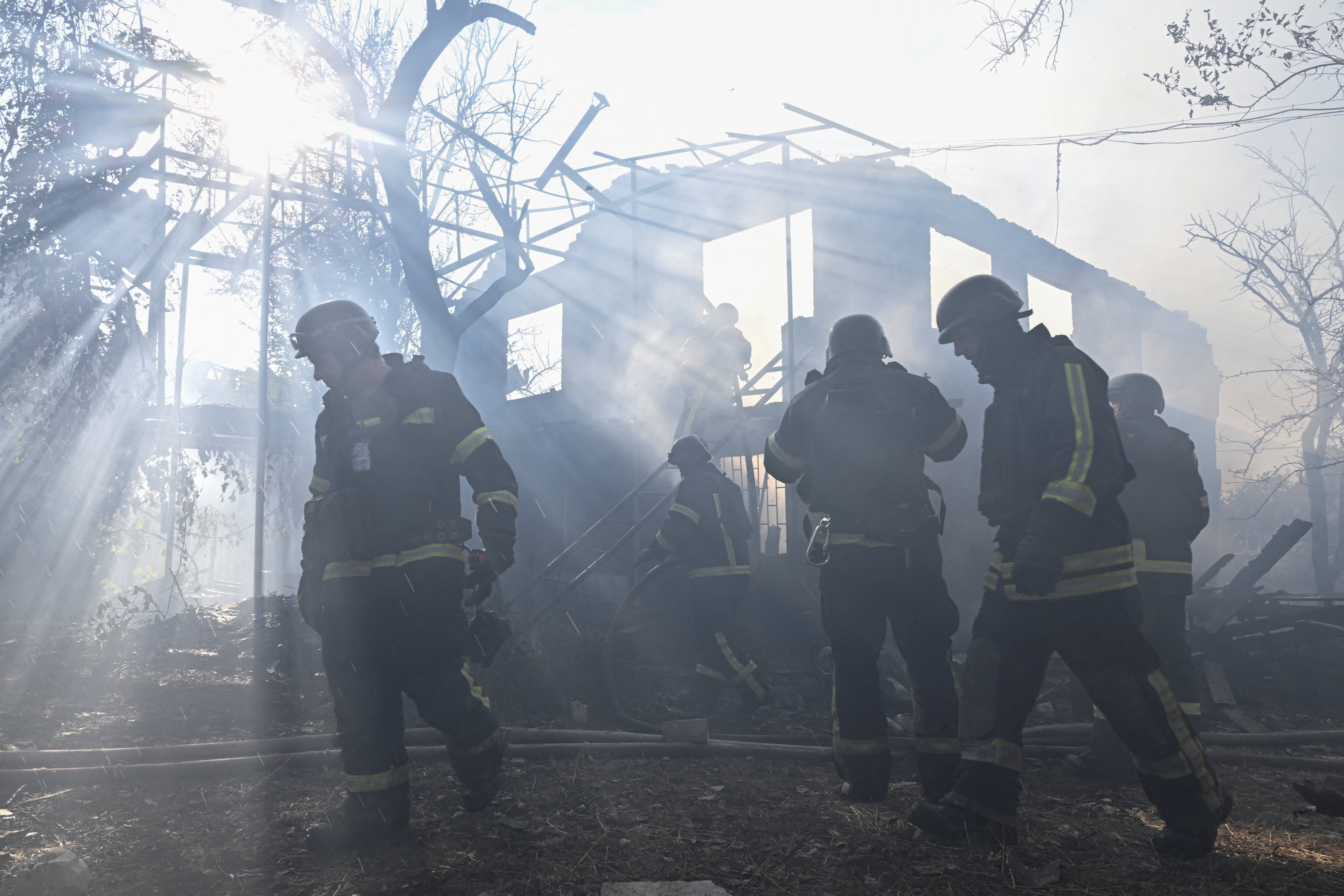 Firefighters work at the site of residential houses hit by a Russian air strike in Zaporizhzhia (Reuters)