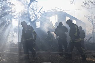 Firefighters work at the site of residential houses hit by a Russian air strike in Zaporizhzhia