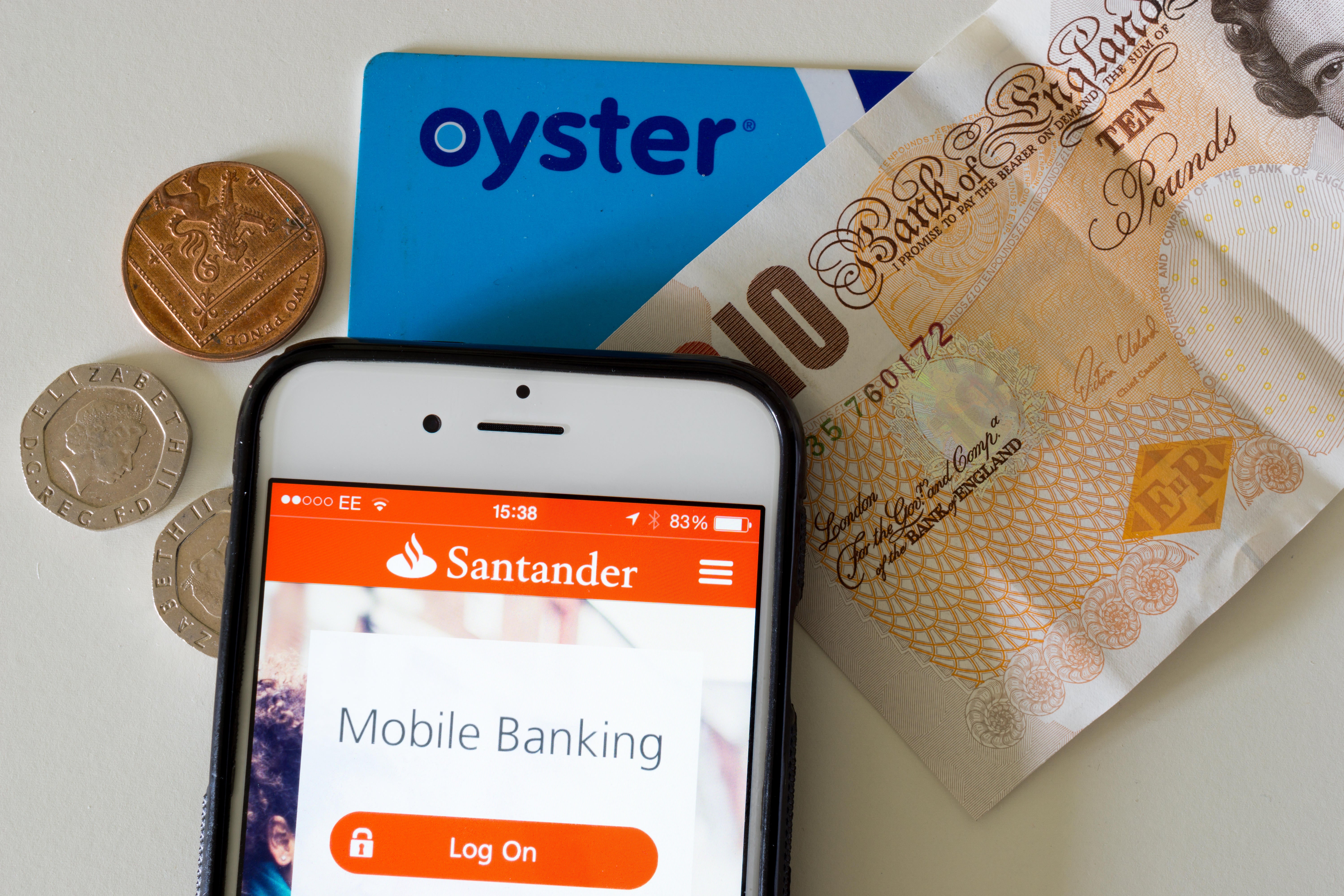 Various modern payment methods; cash, a contactless payment card and mobile banking app displayed on an iPhone 6 (Alamy/PA)