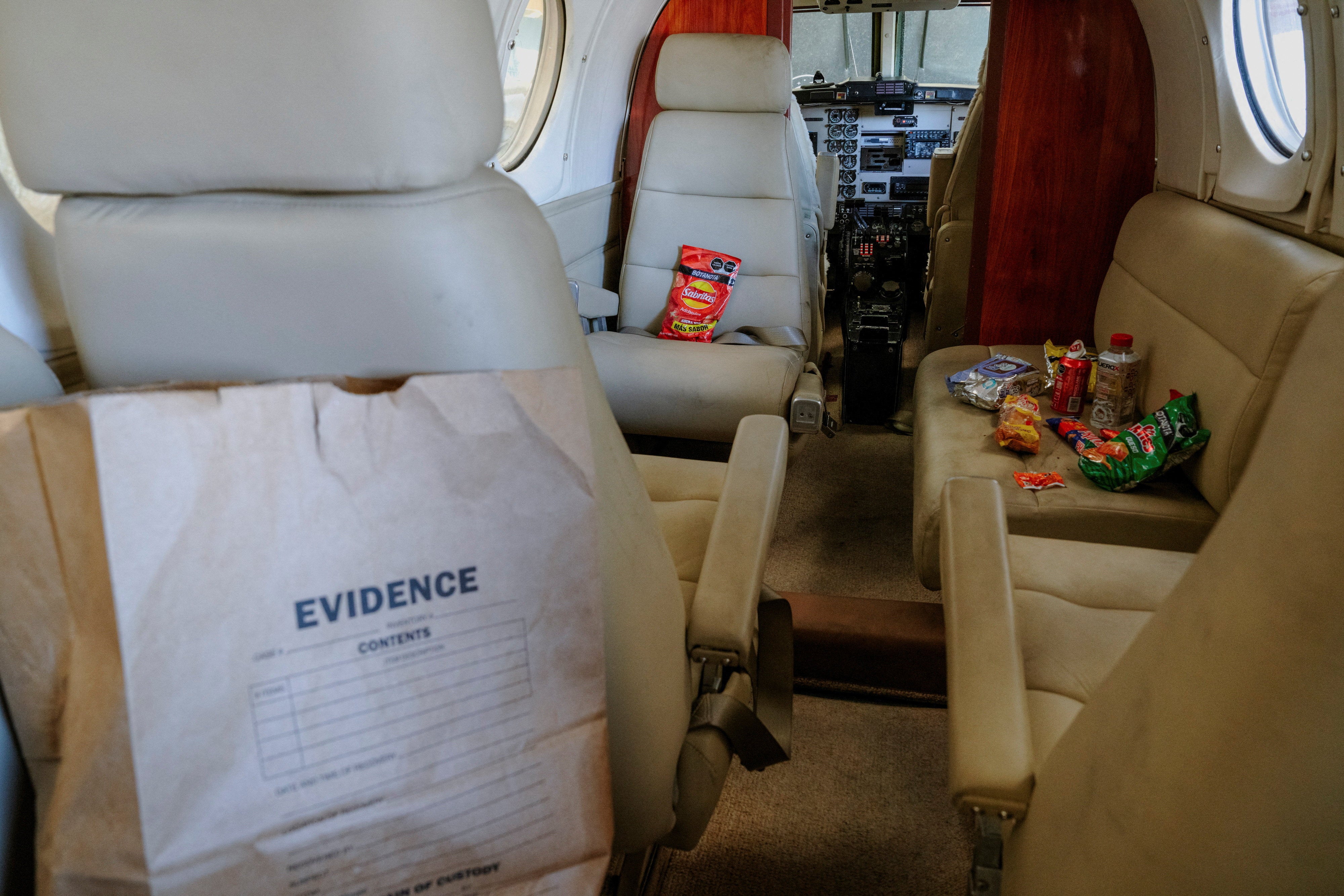 An evidence bag and Mexican snacks sit in the cabin of a Beechcraft King Air aircraft