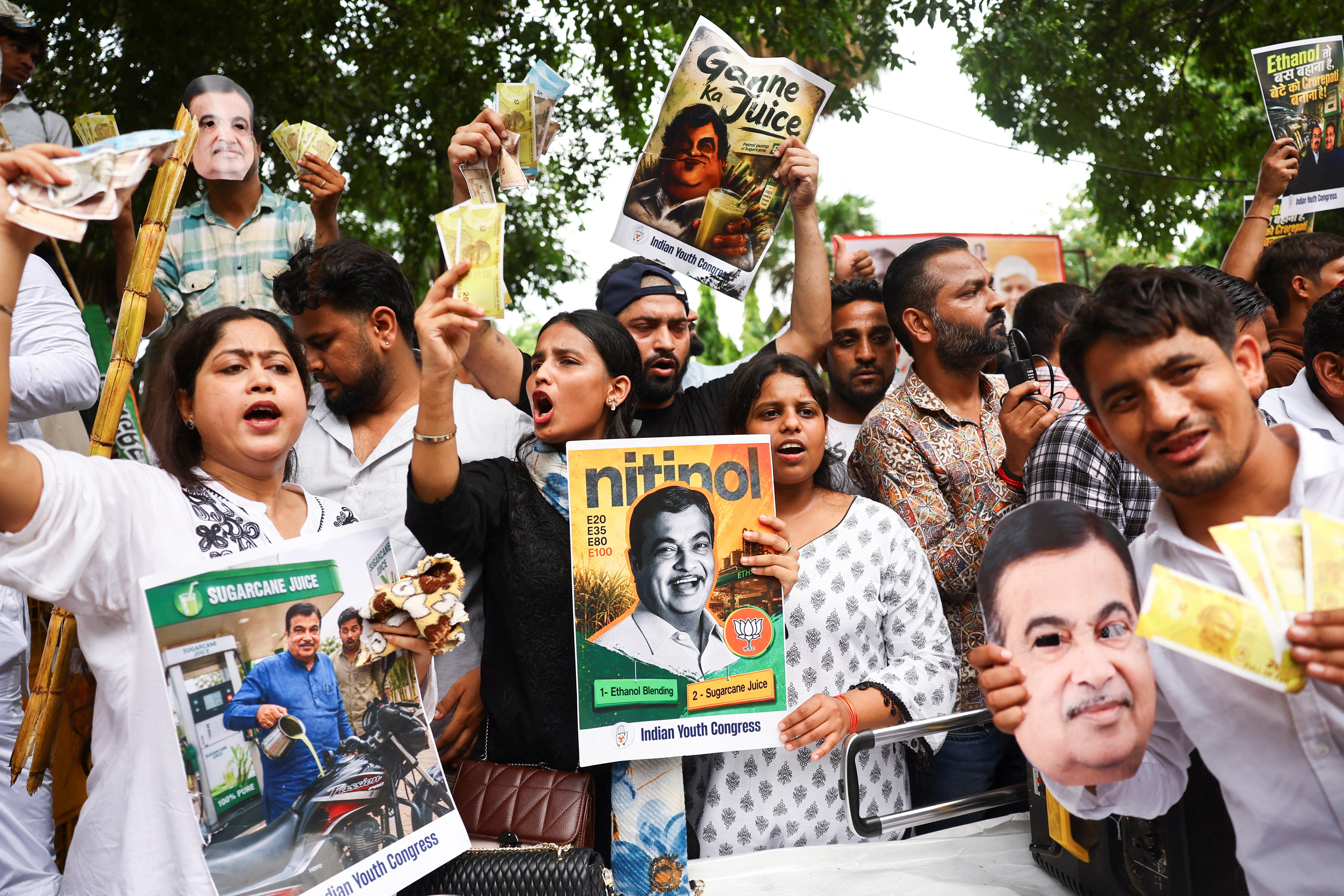 Supporters of Indian Youth Congress hold placards and shout slogans during a protest against government’s 20% ethanol-blended fuel policy