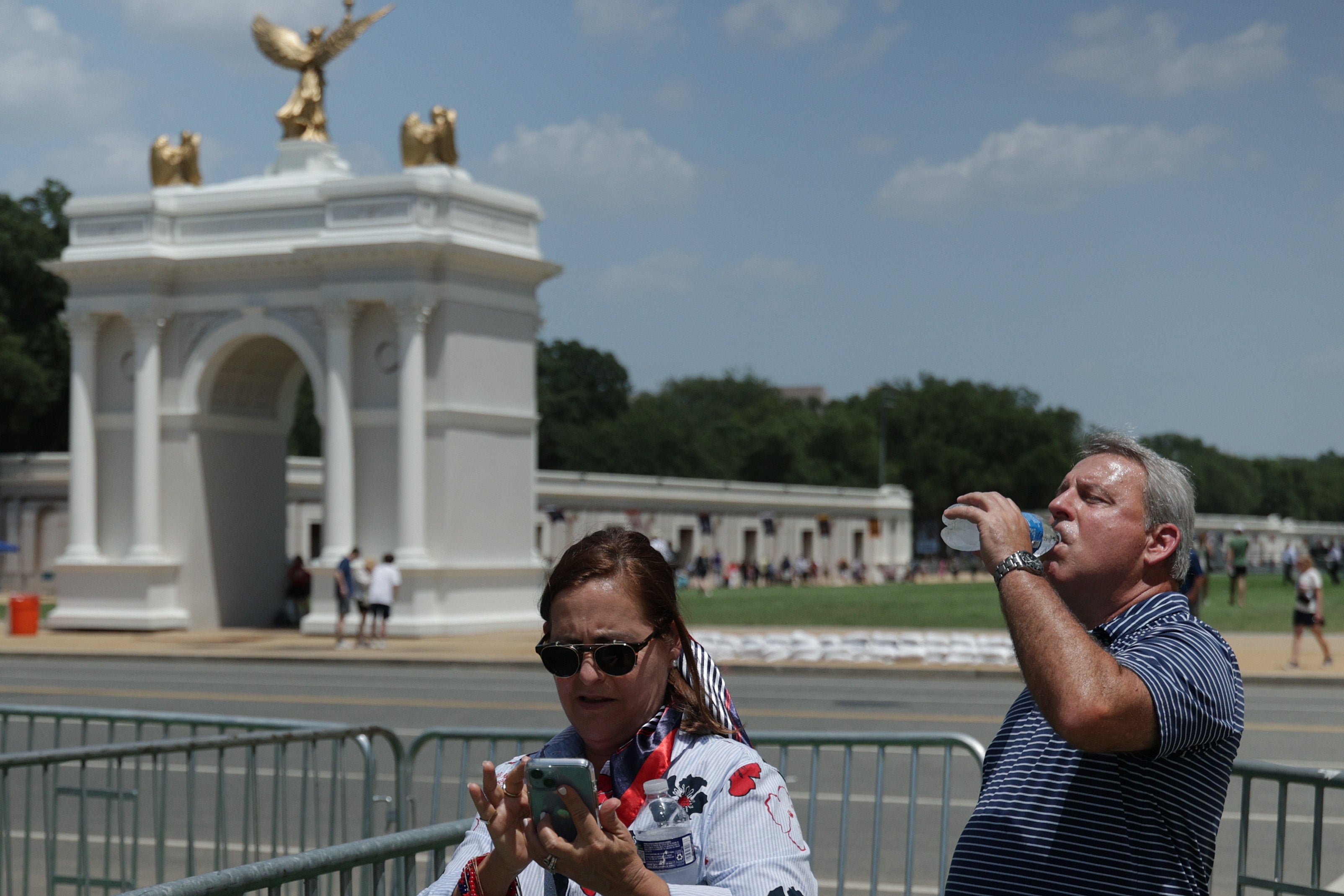 A man drinks from a water bottle during the Great American State Fair on the National Mall in Washington, D.C., earlier this month. Rising temperatures are largely the consequence of burning oil and gas for energy