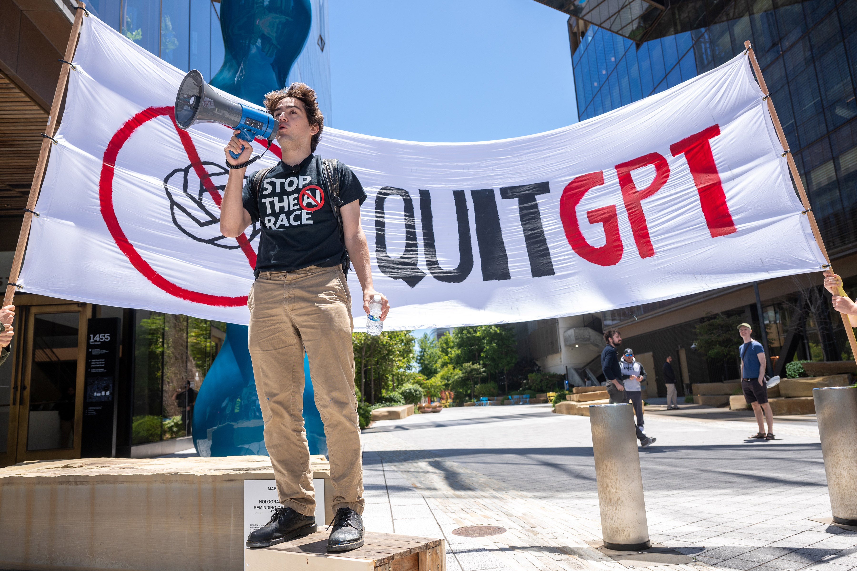 Michael Trazzi, founder and CEO of The Inside View media company producing documentaries about AI Safety, speaks out against the AI race in front of the offices of Open AI during the ‘Stop the AI Race’ protest march in San Francisco (AFP/Getty)