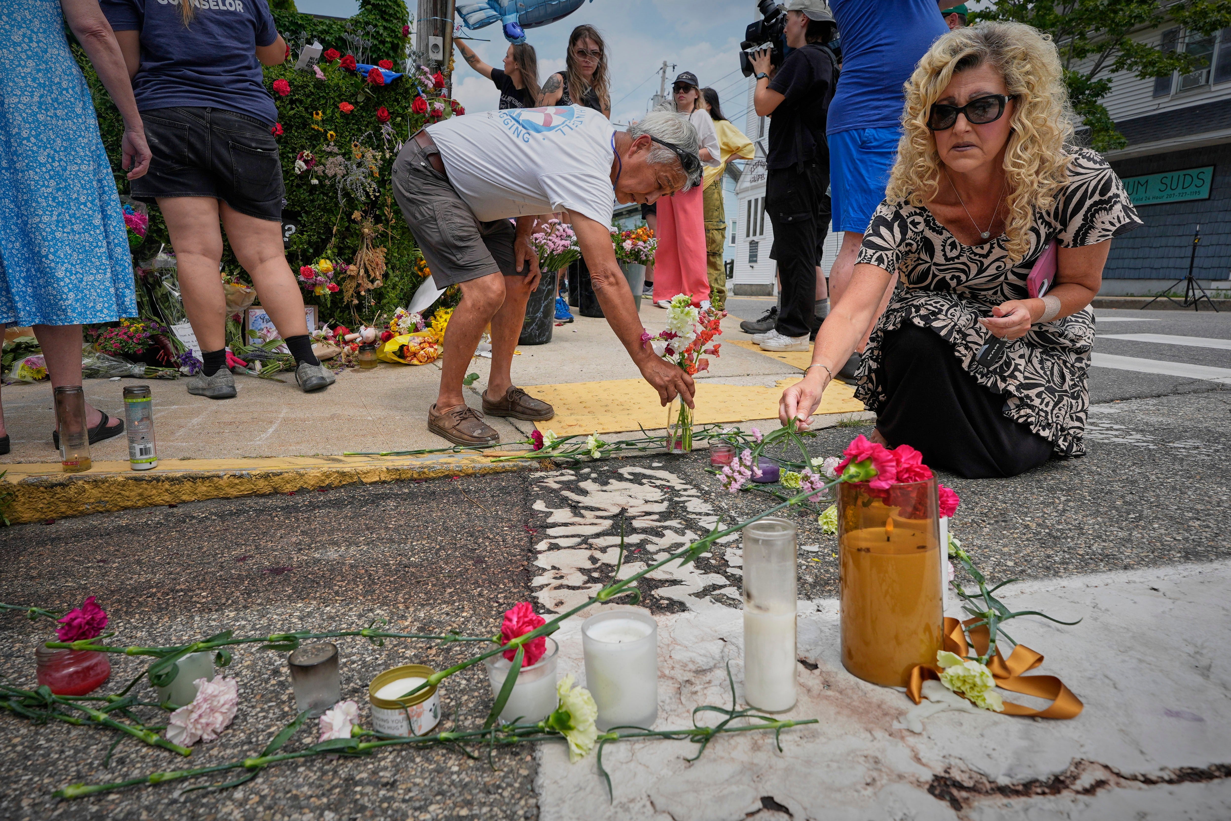 Mourners place flowers and candles in Biddeford, Maine, near the blood-stained pavement where Guerrero was pulled from his car on Monday by U.S. Immigration and Customs Enforcement agents (AP Photo/Robert F. Bukaty)
