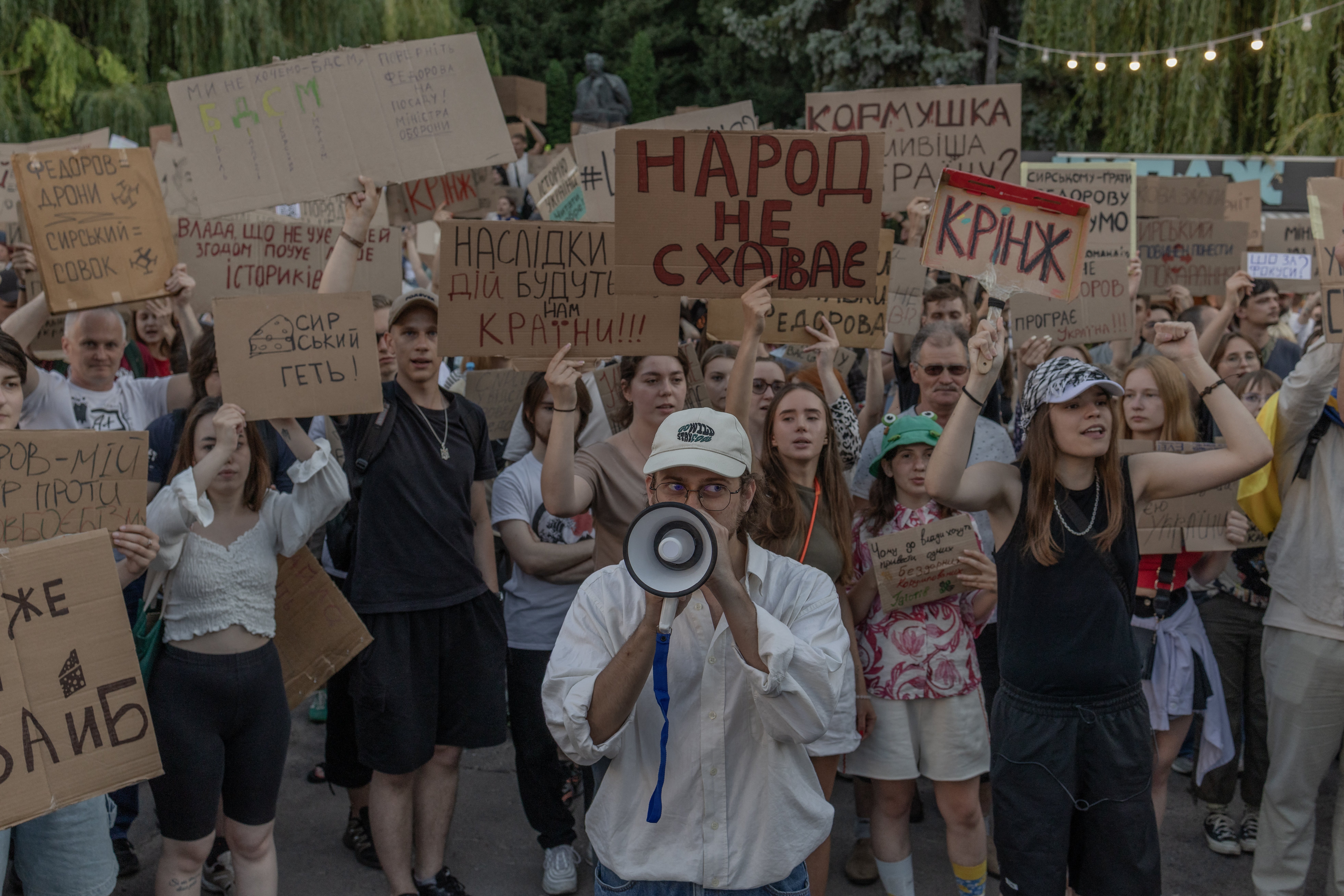 Protesters hold placards and chant slogans during a demonstration against Ukraine's president's decision to dismiss defence minister Mykhailo Fedorov, in Kyiv on 17 July