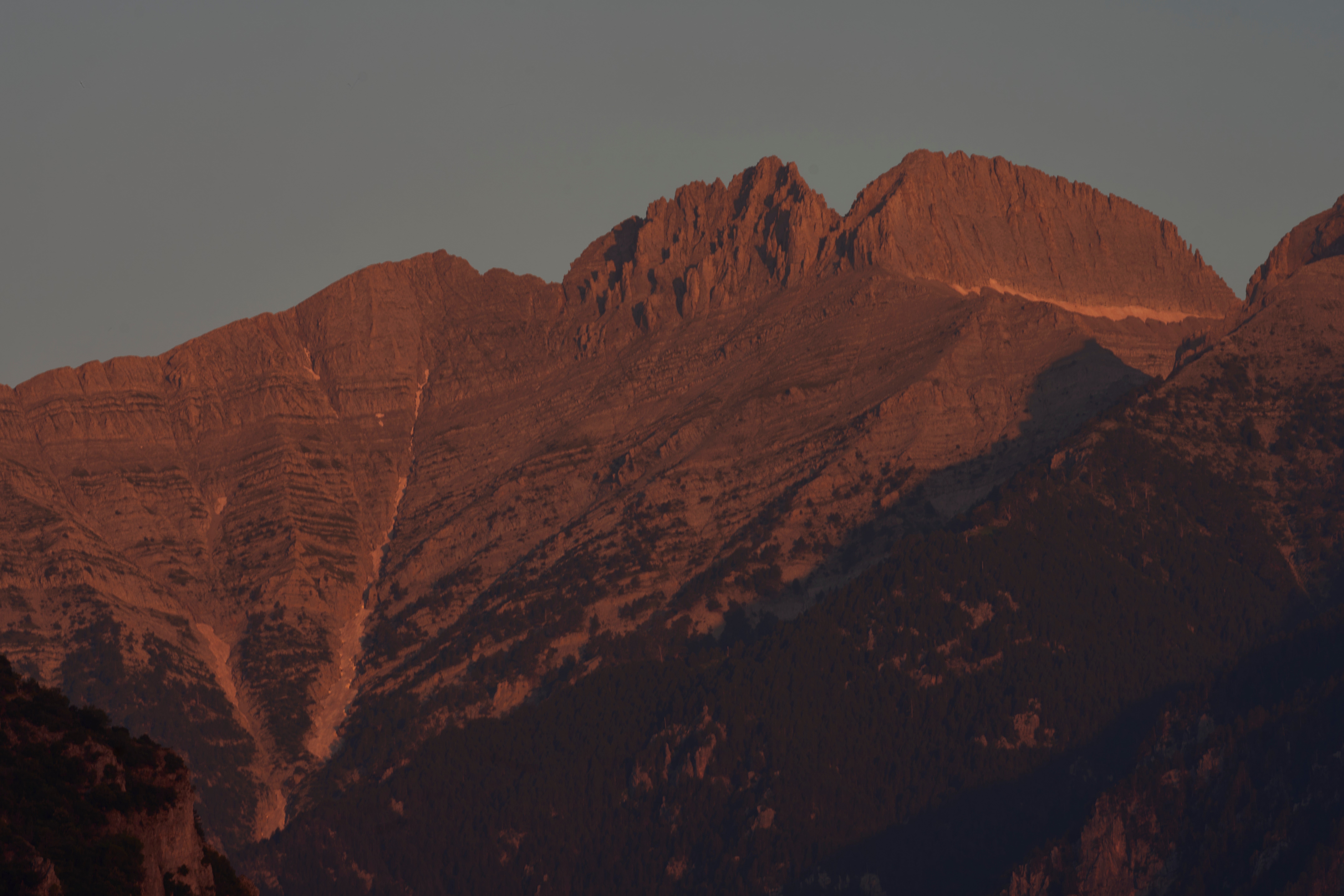 The morning light shines on Mytikas, Greece's highest peak, center left, and Stefani, known as the Throne of Zeus, center right, atop Mount Olympus