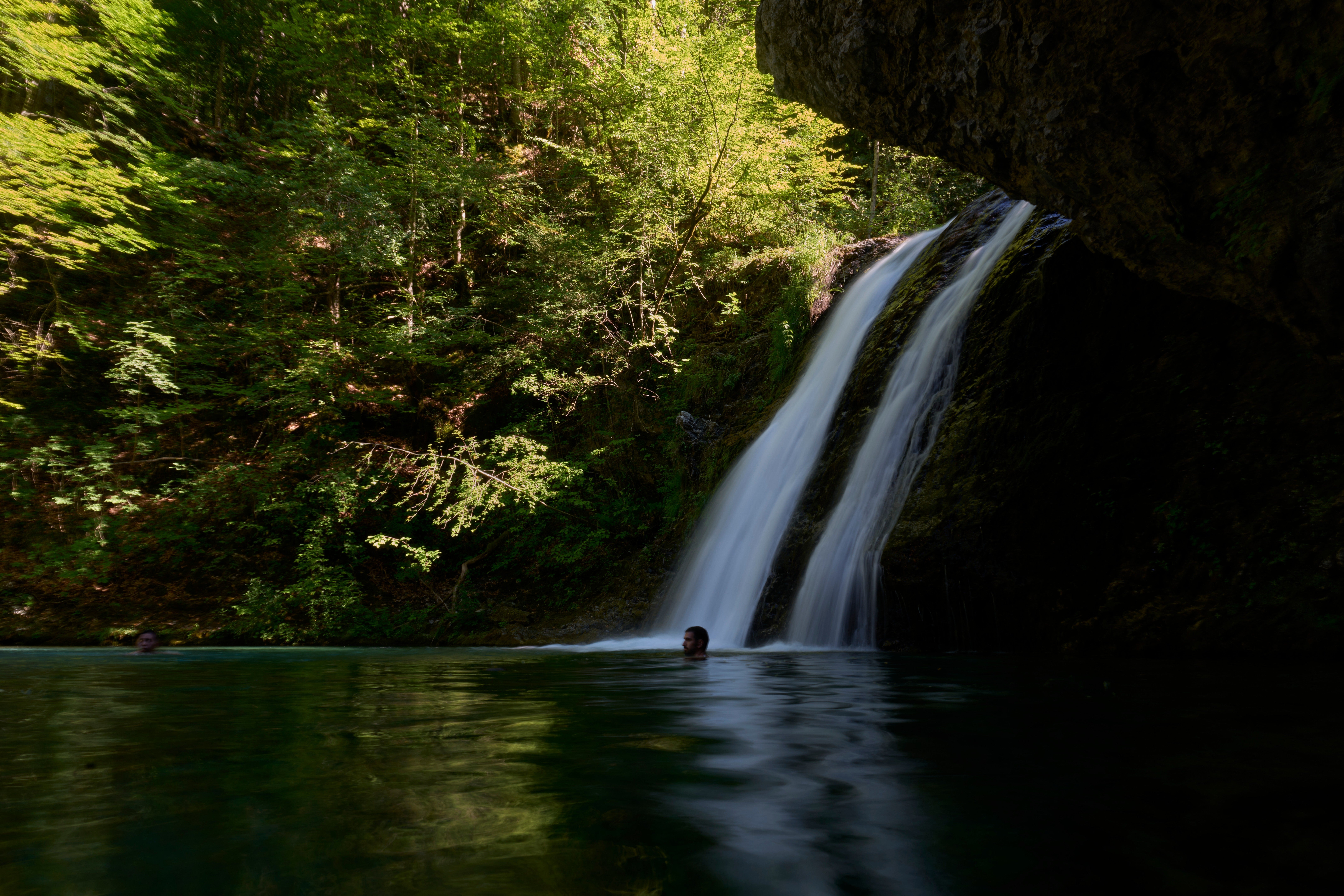 People swim beneath a waterfall in the Enipeas Gorge on Mount Olympus in northern Greece