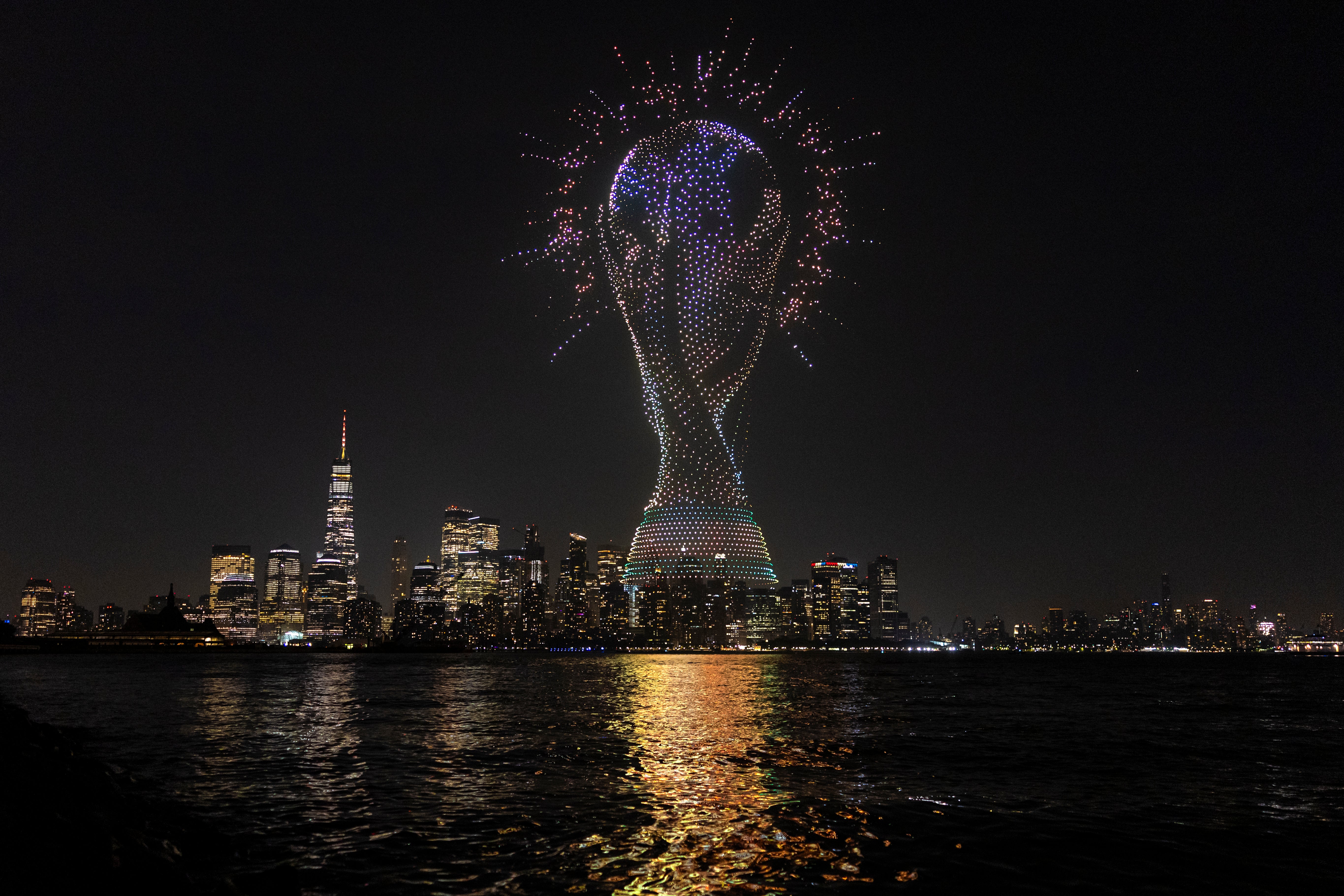 A general view as a drone show takes place over the New York Harbour, displaying a graphic of the FIFA World Cup trophy (Getty)