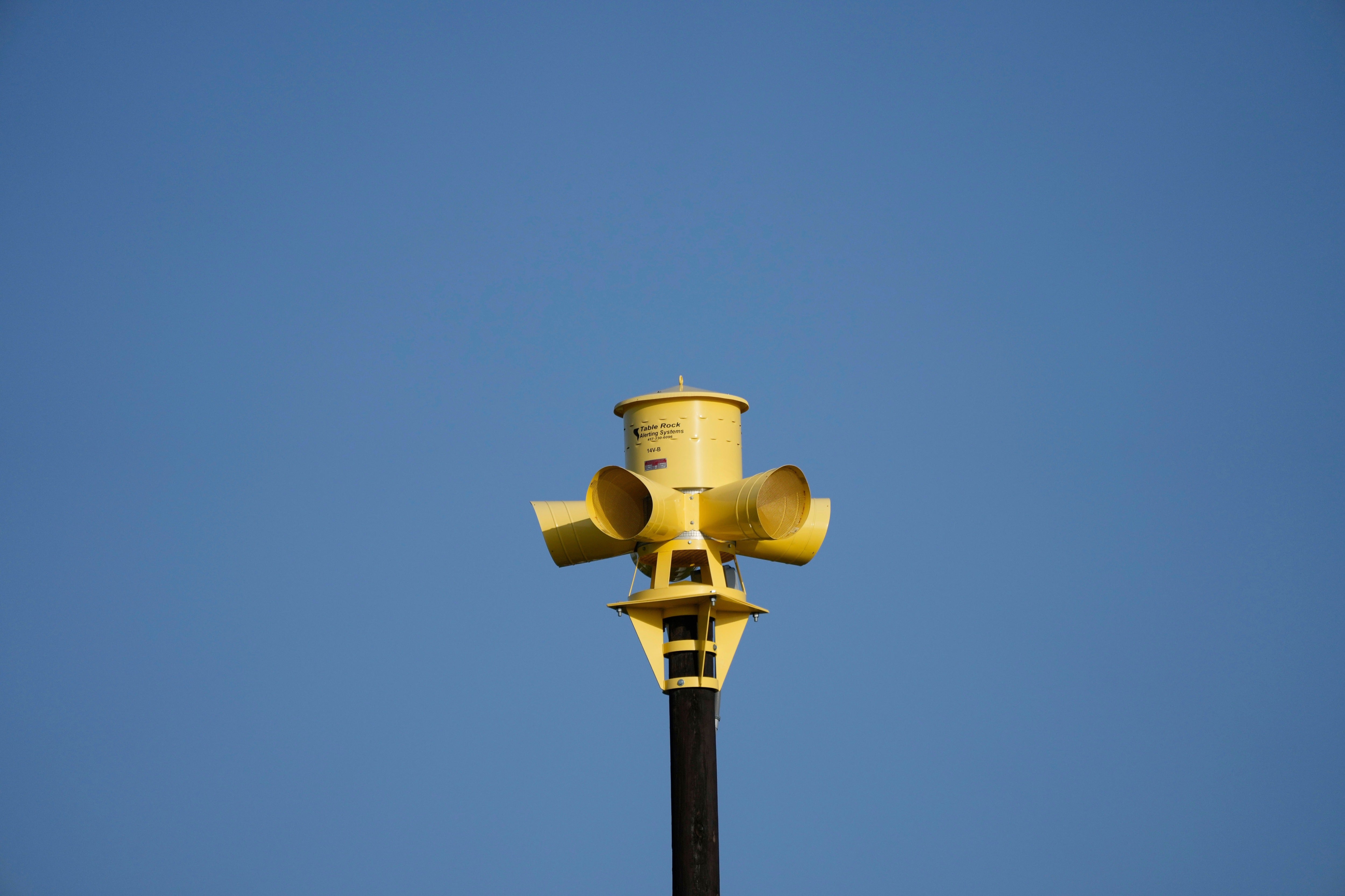 An emergency siren is visible on top of the Comfort Volunteer Fire Department in Comfort, Texas, July 10, 2025