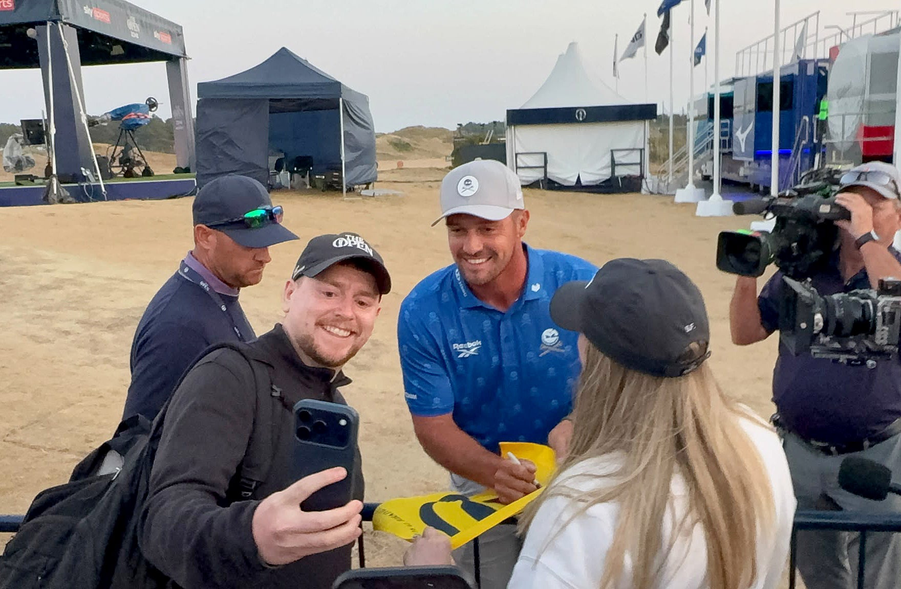 Bryson DeChambeau still posed for selfies as he went to the range after being informed of the ruling (PA Wire) (PA Wire)