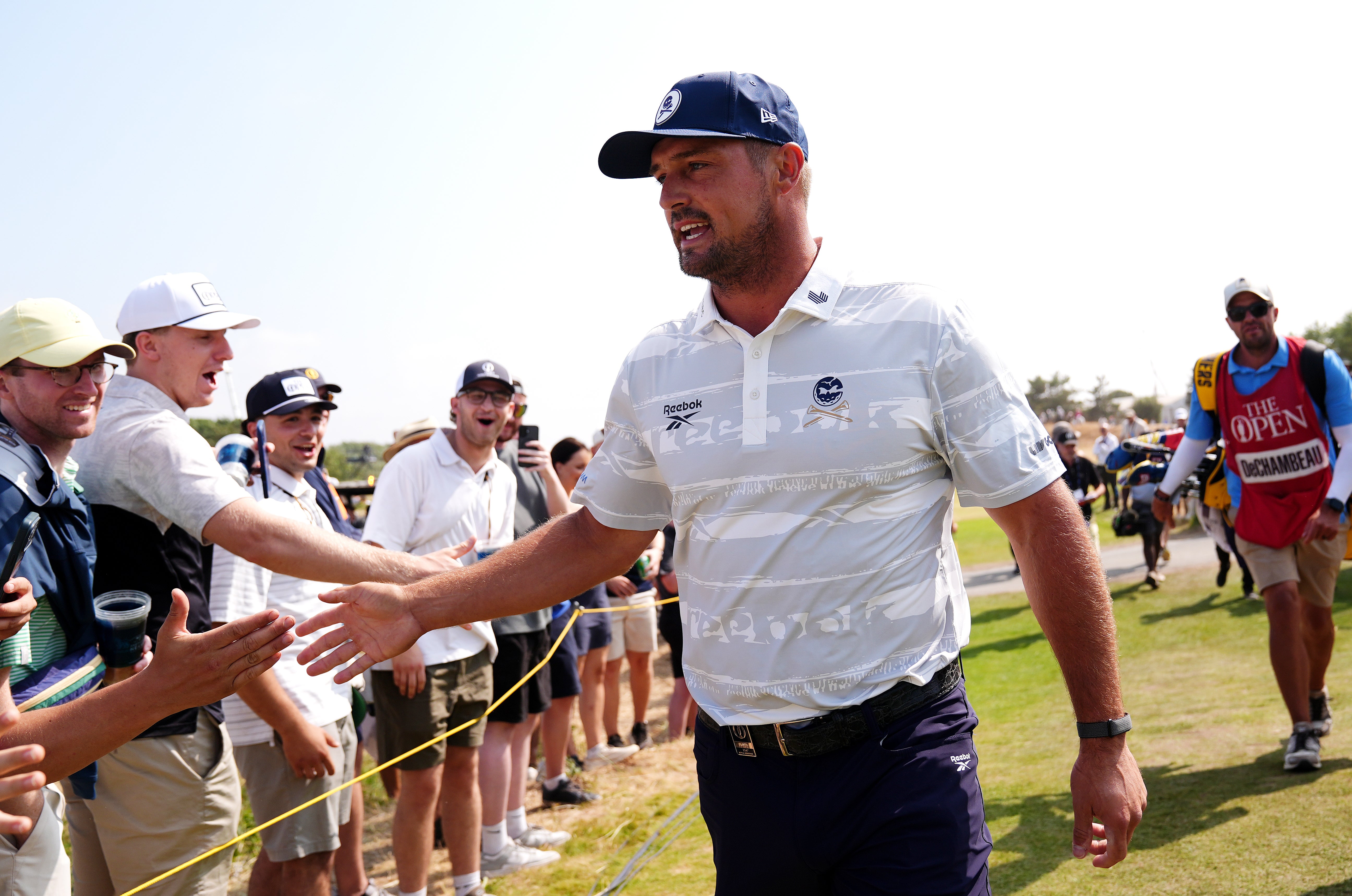 Bryson DeChambeau embraces spectators on his way to the second tee (Jacob King/PA).