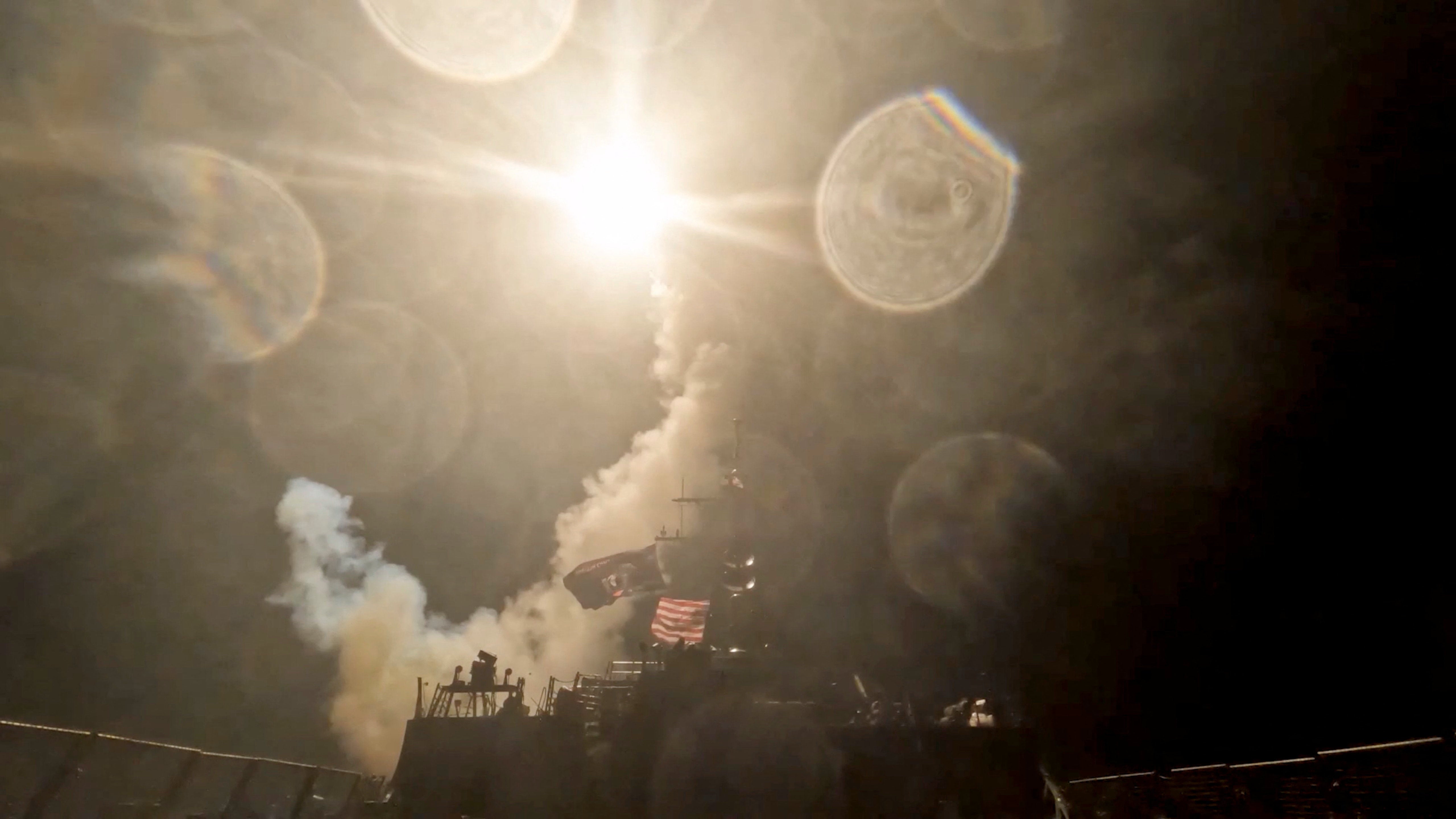 A US warship launches a munition at an unknown location during what the US military says is its latest wave of strikes on Iran
