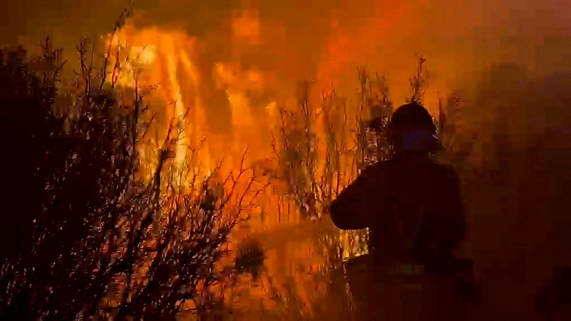 A firefighter works at a site, following a wildfire in the municipality of Ores, northern Aragon region
