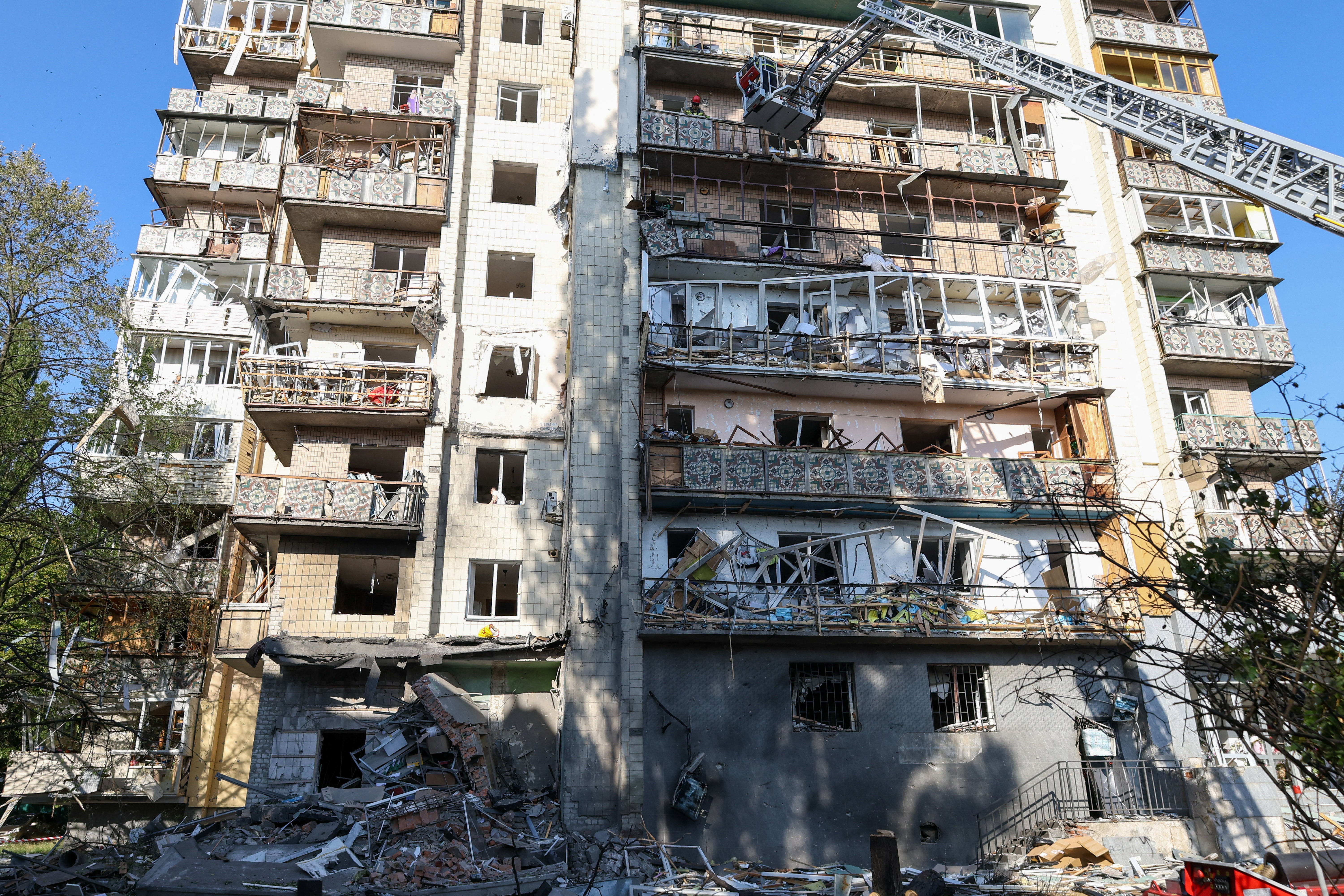 Rescuers work on a residential building following a Russian missile strikes in Kyiv