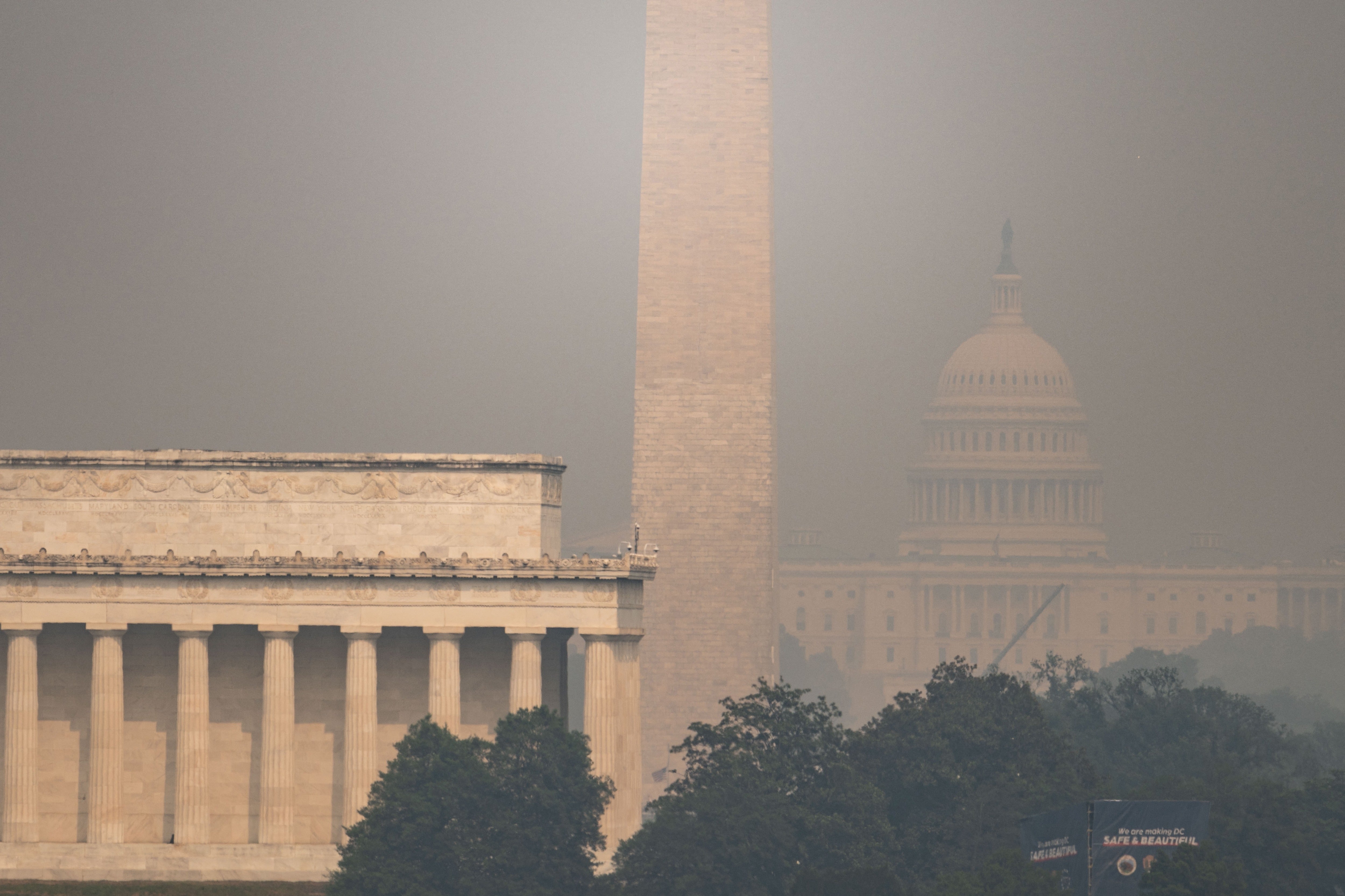 The US Capitol, Washington Monument and Lincoln Memorial are seen through haze caused by wildfire smoke from Canada from the Netherlands Carillon in Arlington, Virginia on July 17, 2026