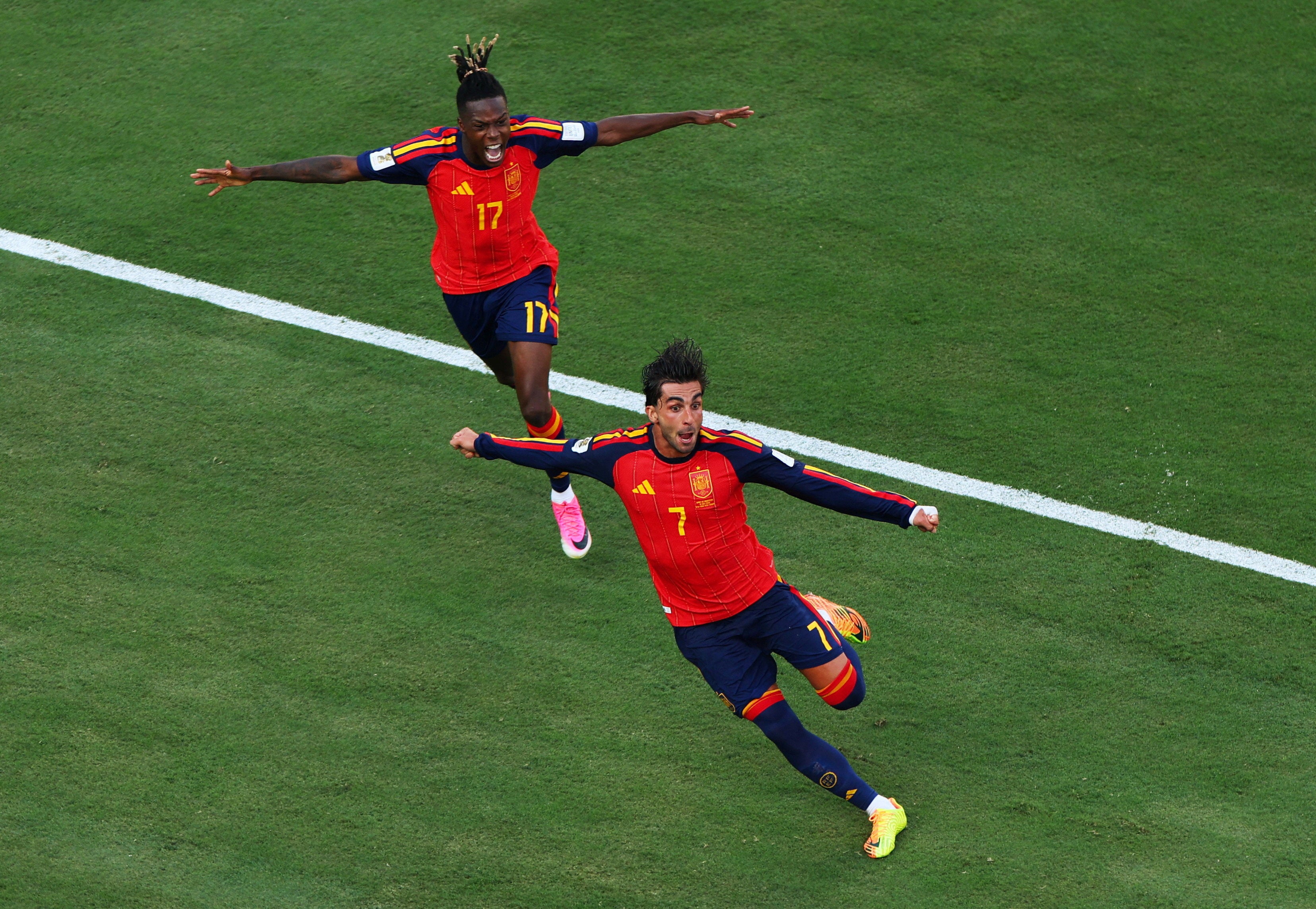 Spain's Ferran Torres celebrates scoring their first goal with Nico Williams