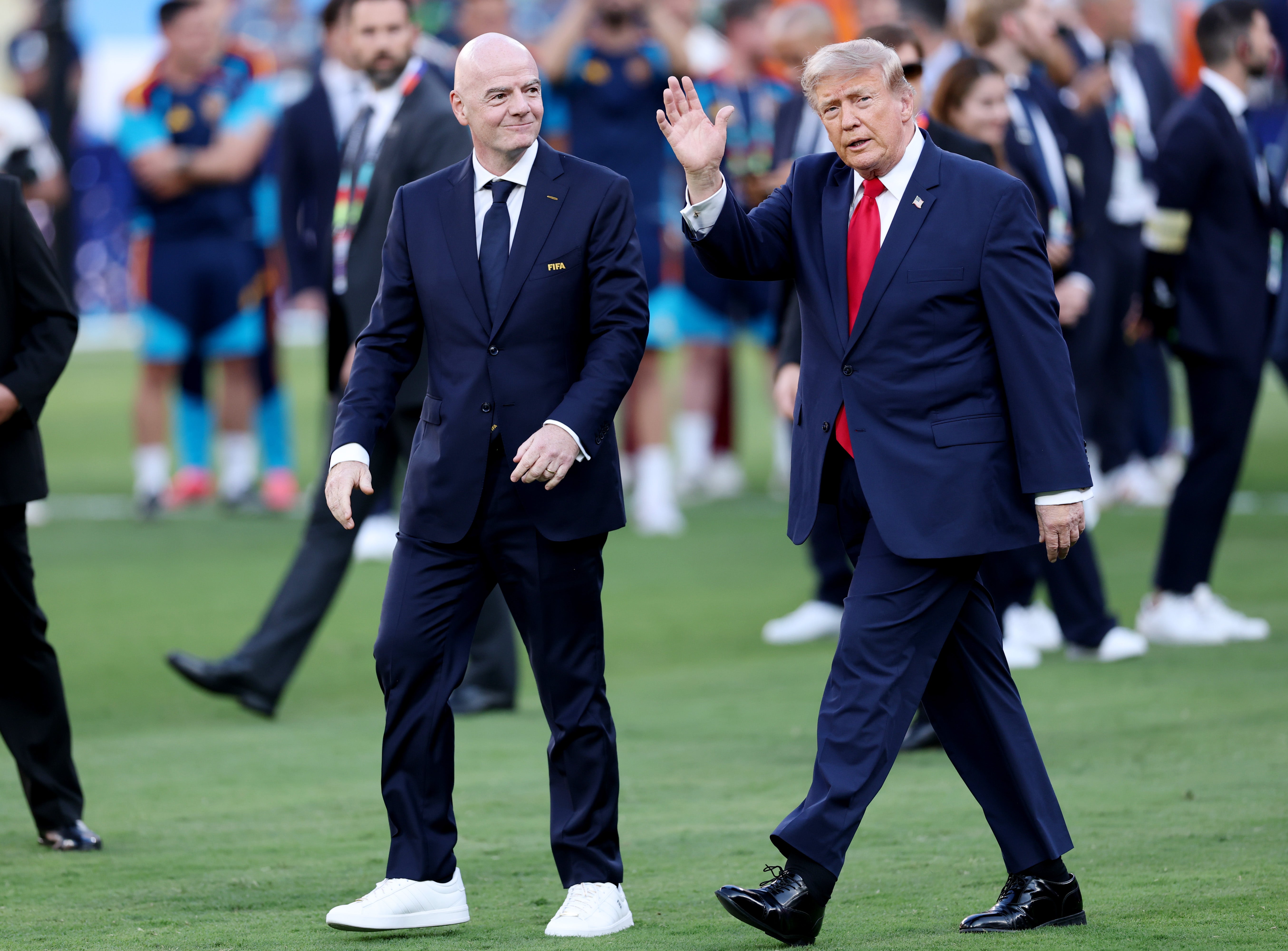 Gianni Infantino and Donald Trump walk onto the pitch before the World Cup presentation