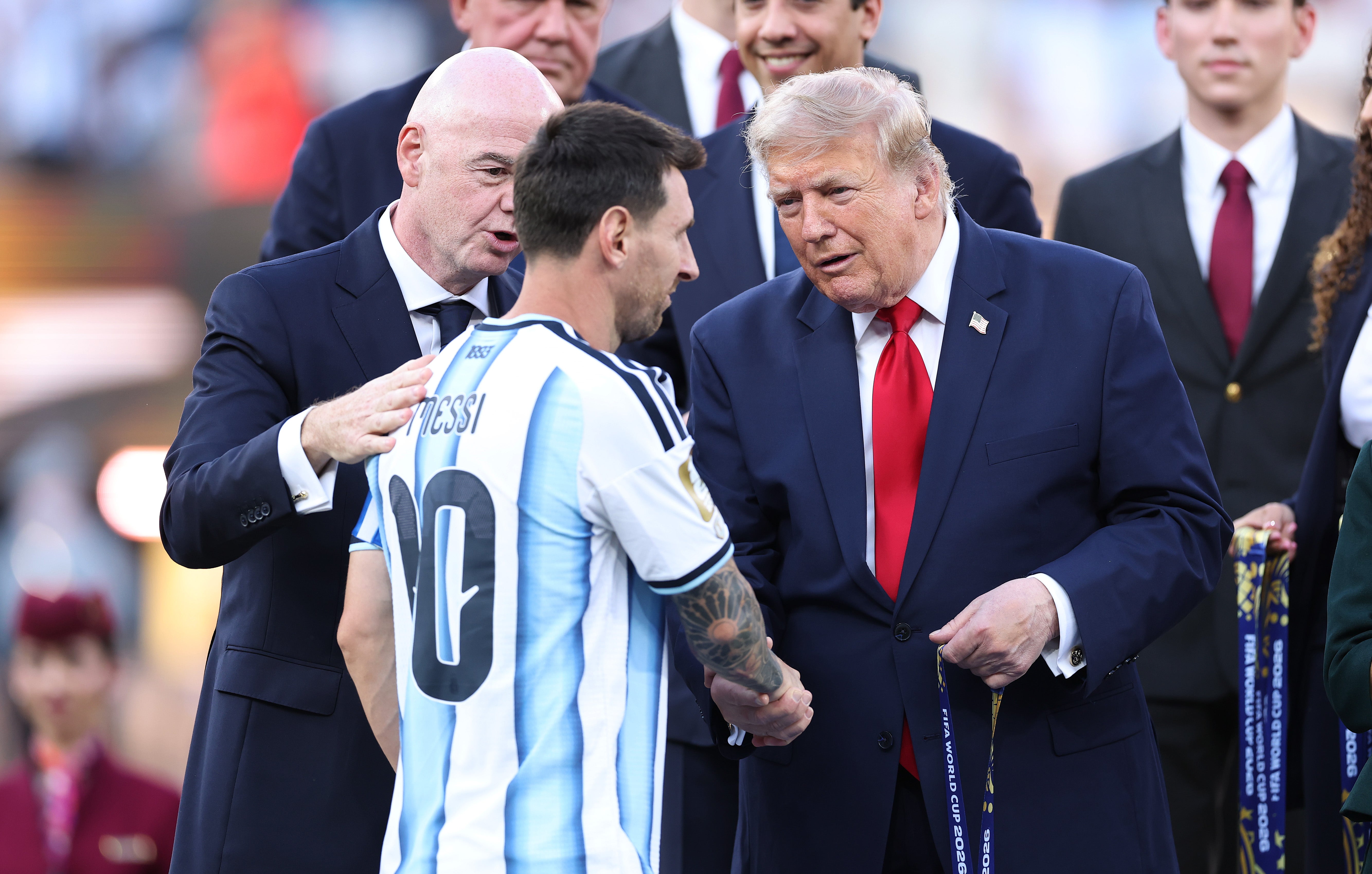 Messi receives his runner-up medal from Donald Trump