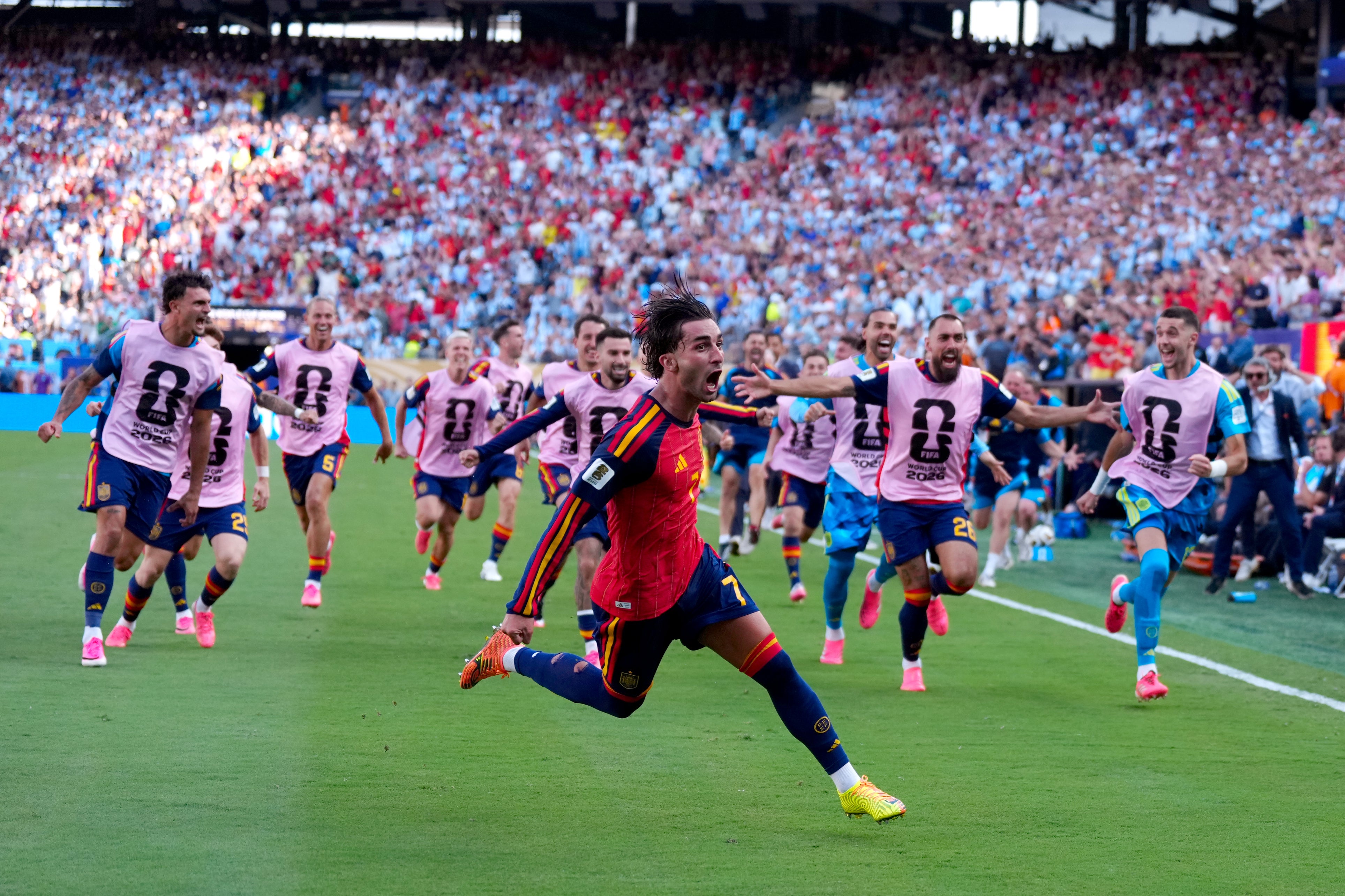 Torres celebrates as Spain's substitutes run to join him