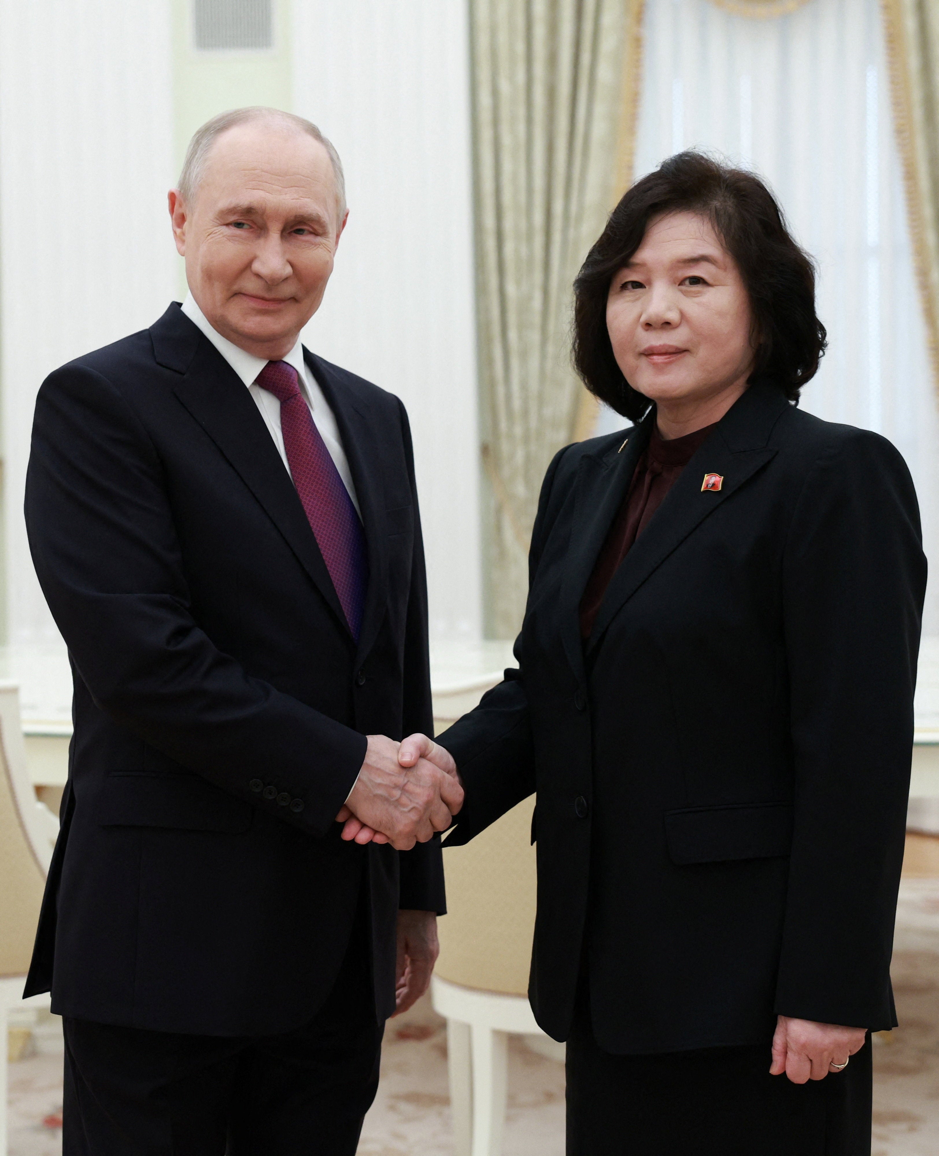 Vladimir Putin shakes hands with North Korean foreign minister Choe Son Hui during a meeting at the Kremlin in Moscow
