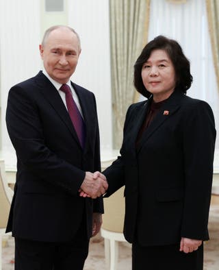 Vladimir Putin shakes hands with North Korean foreign minister Choe Son Hui during a meeting at the Kremlin in Moscow