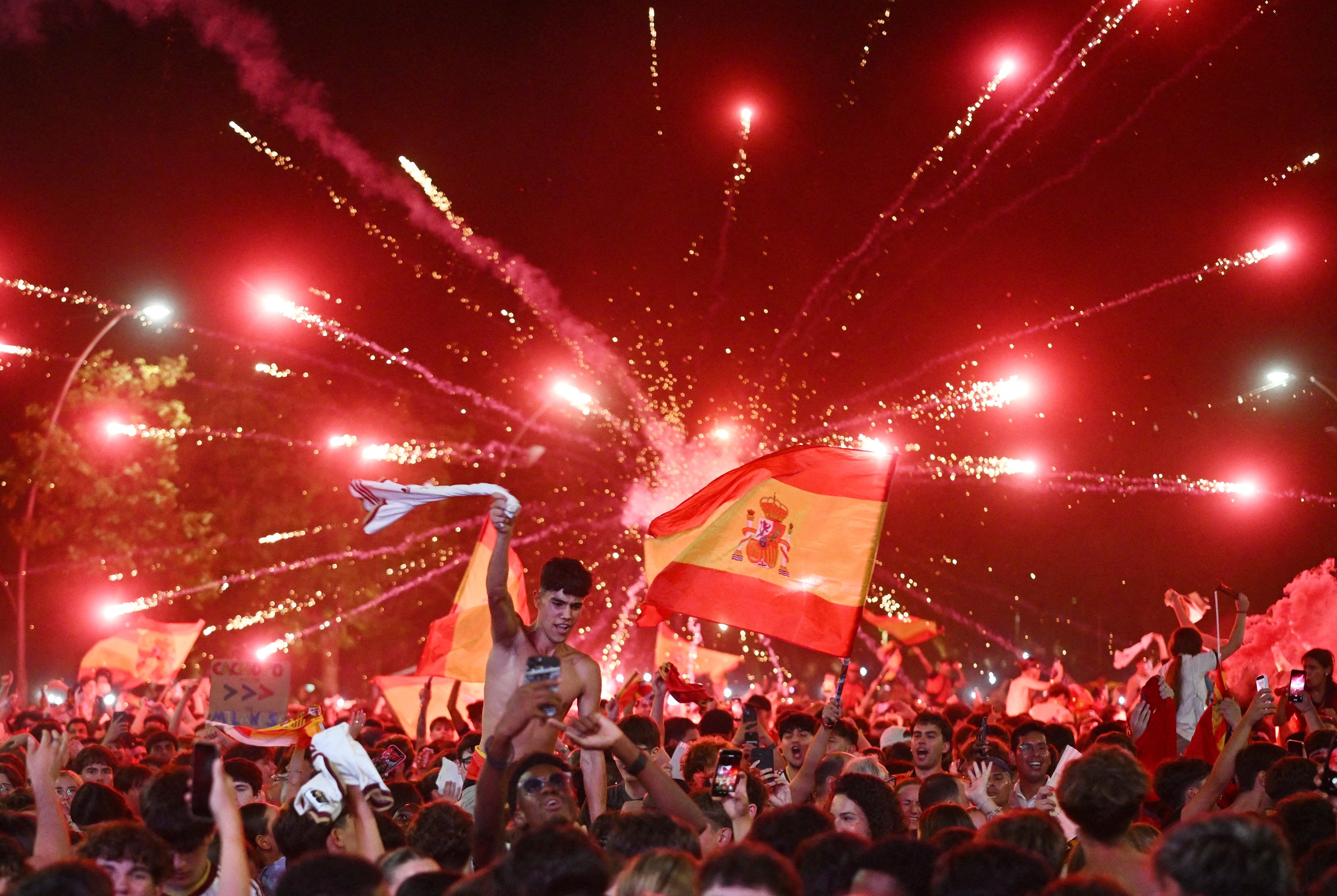 Spain fans celebrate their first goal as they watch in Lamine Yamal's hometown - Rocafonda.