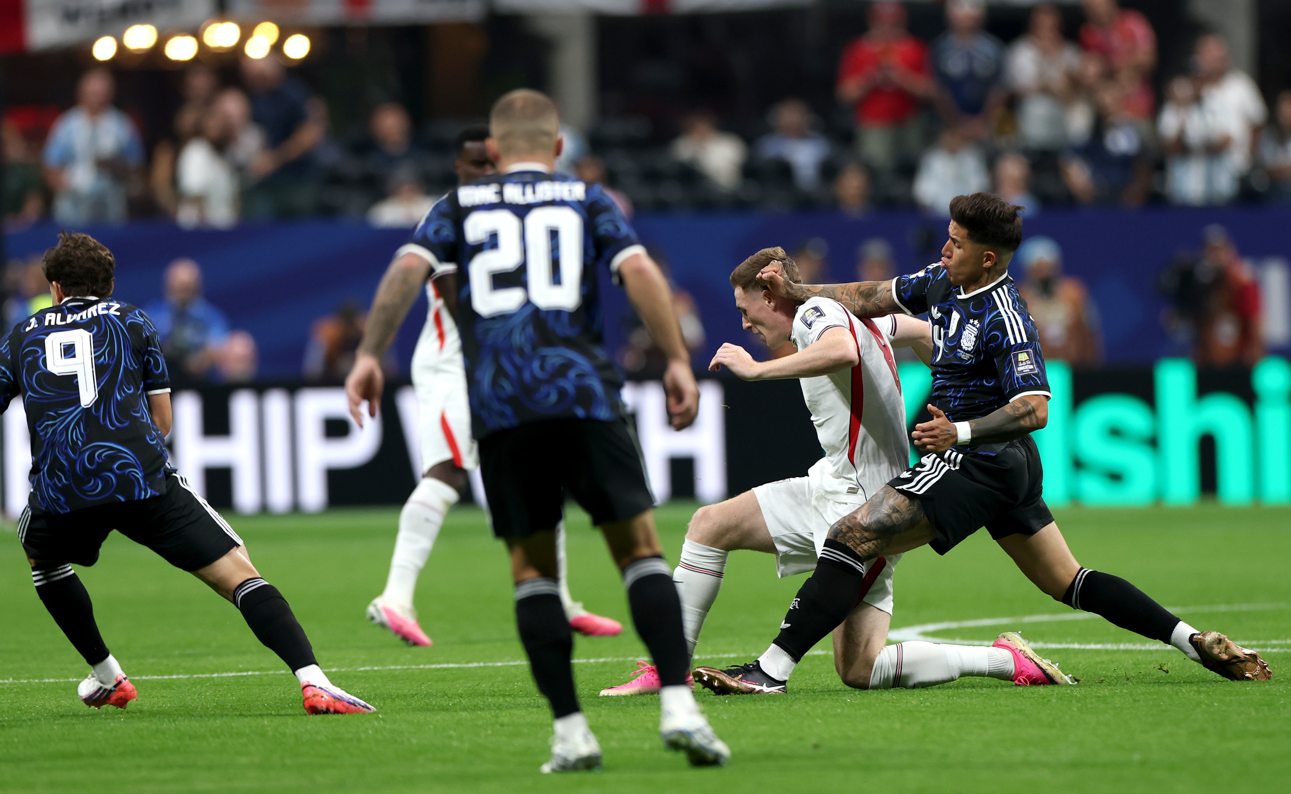 Elliot Anderson #8 of England is challenged by Enzo Fernandez #24 of Argentina