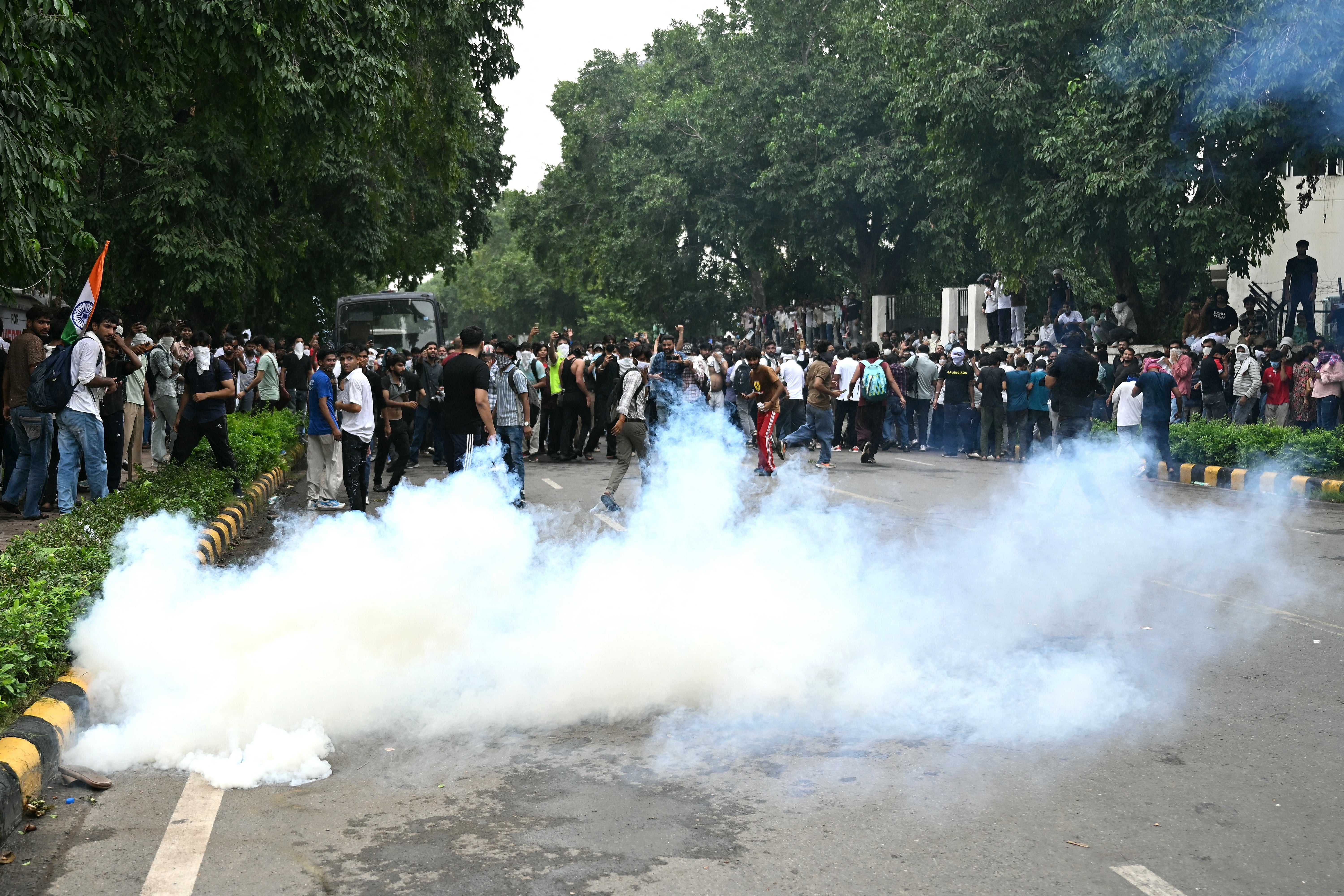 Activists and supporters of the Cockroach Janta Party disperse after police fire teargas during a protest in Delhi (AFP/Getty)