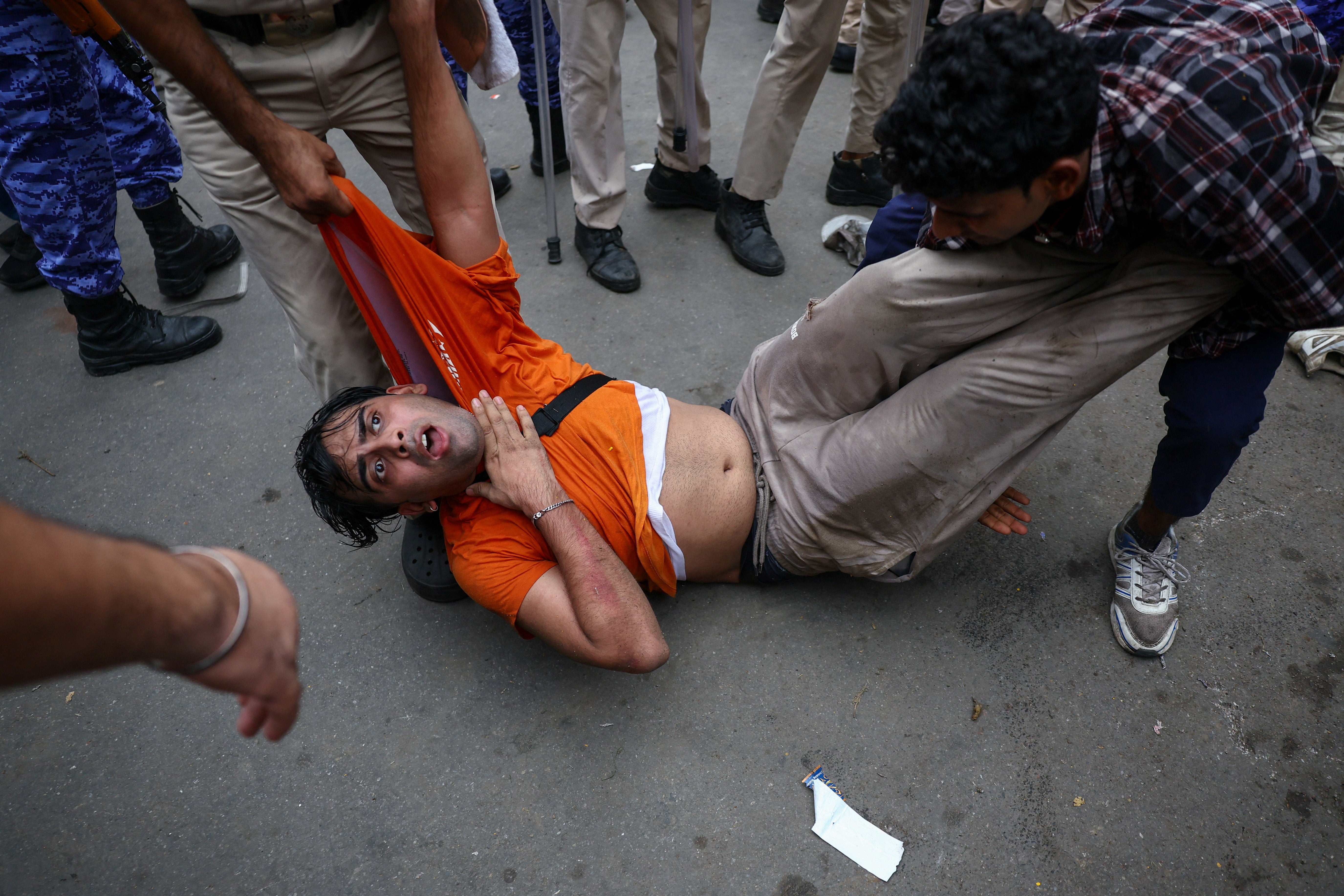 A protester from the Cockroach Janta Party is dragged by police