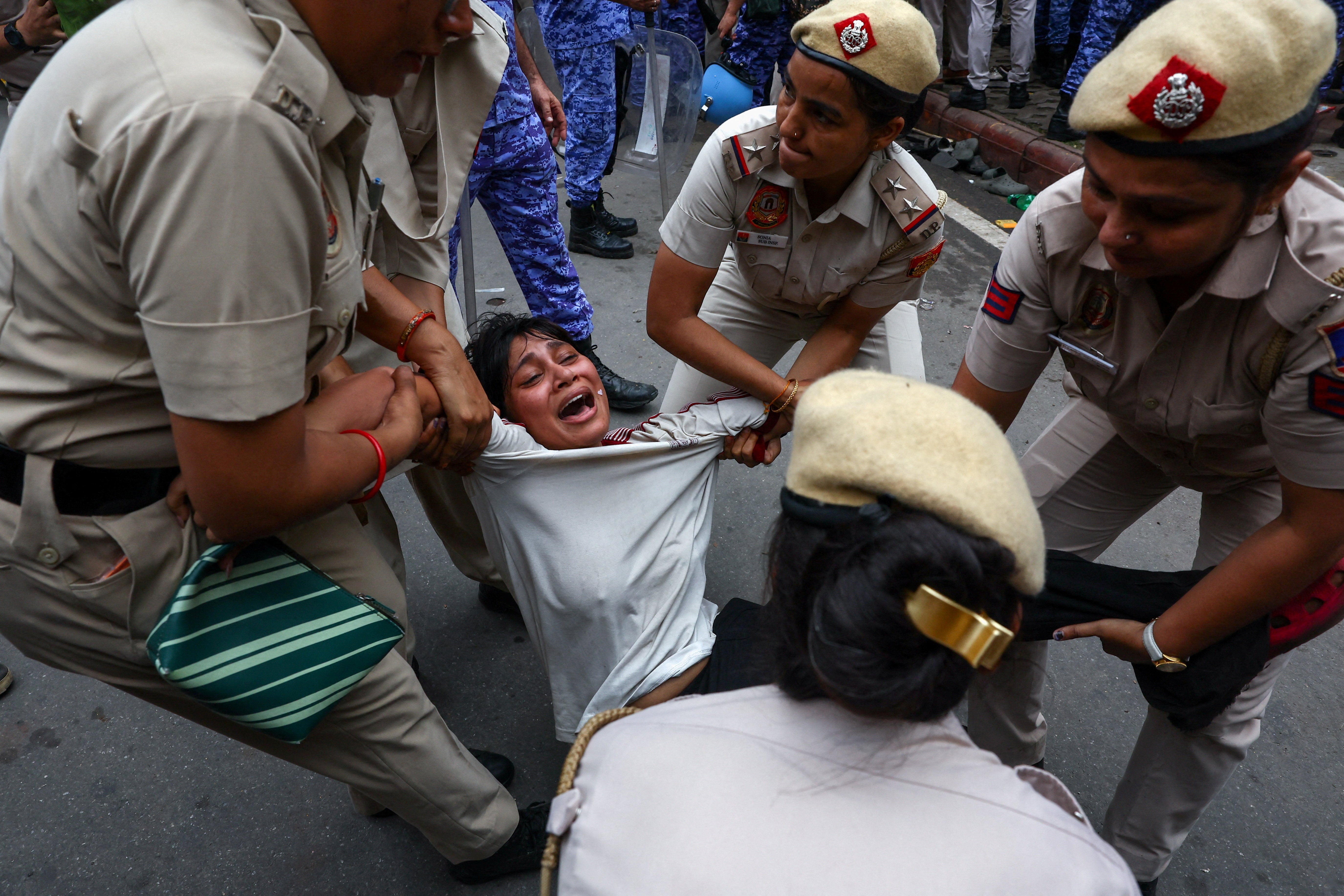 Police officers remove a protester (Reuters)