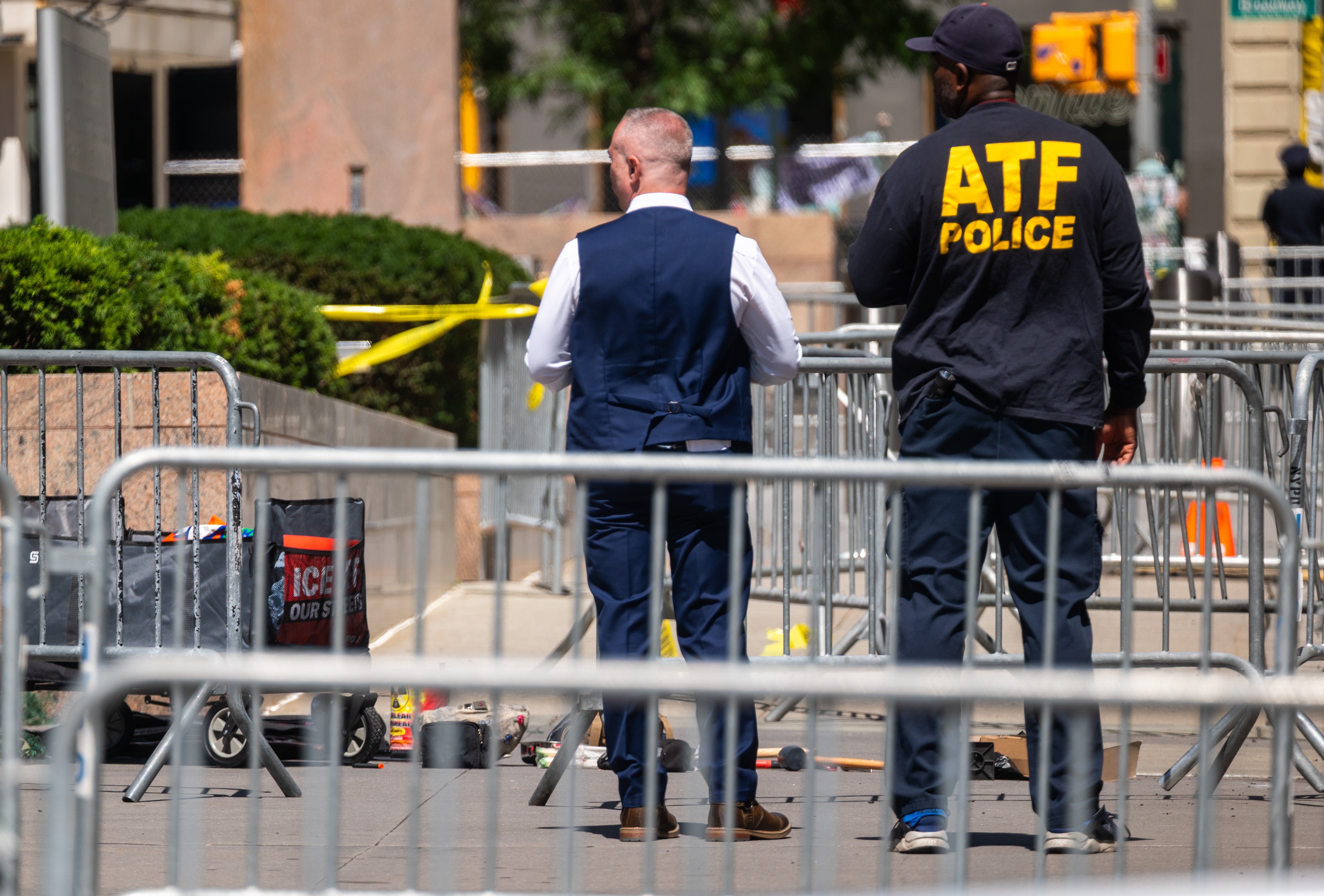 Law enforcement officials quickly responded to the scene outside the federal building where a suspect set fire to clear liquid and canisters. The suspect allegedly brought a cart with an anti-ICE message written on it (Getty)