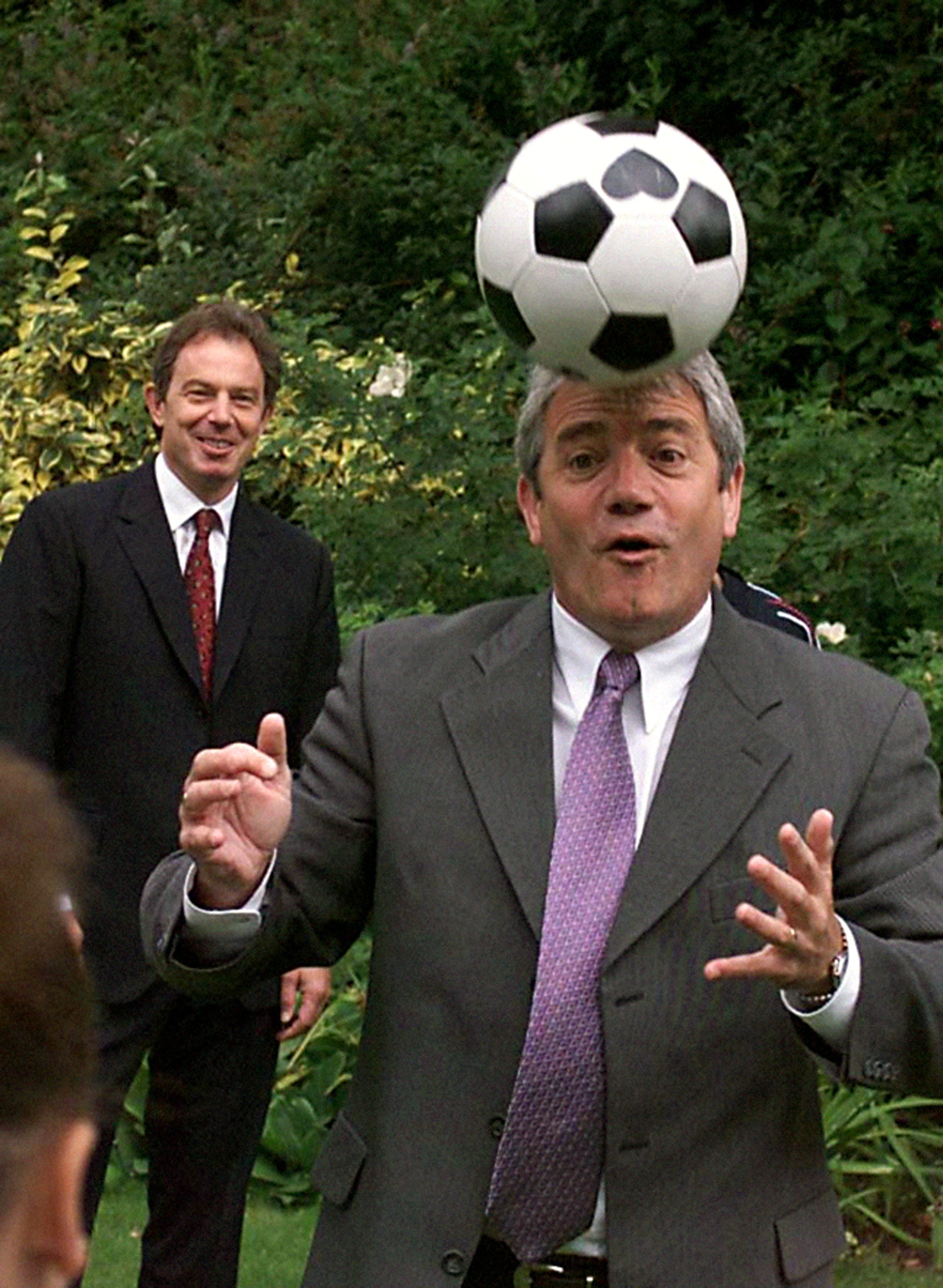 Then-England football manager Kevin Keegan heads a ball as Tony Blair watches in the back garden of 10 Downing Street (Sean Dempsey/PA) (PA Archive)