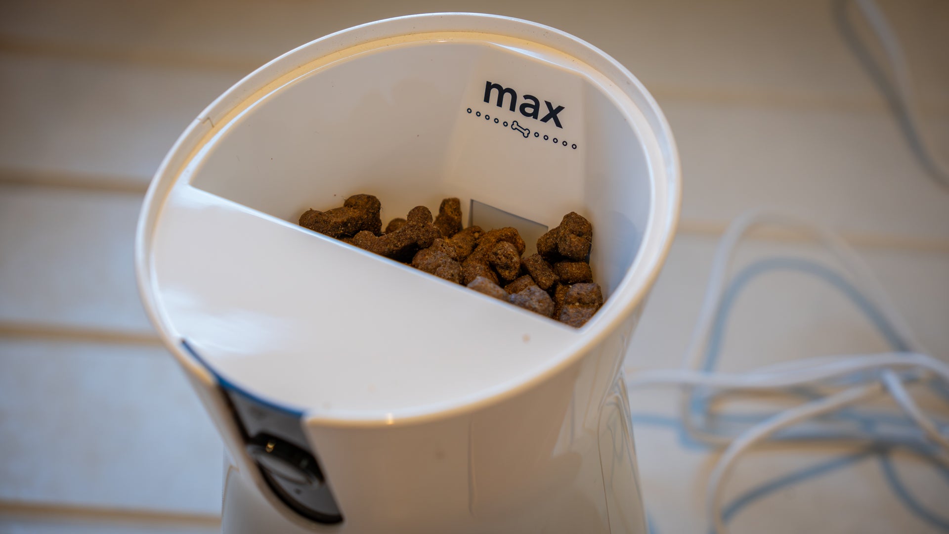The Furbo holds up to 100 treats under its air-tight bamboo lid (Alistair Charlton / The Independent)