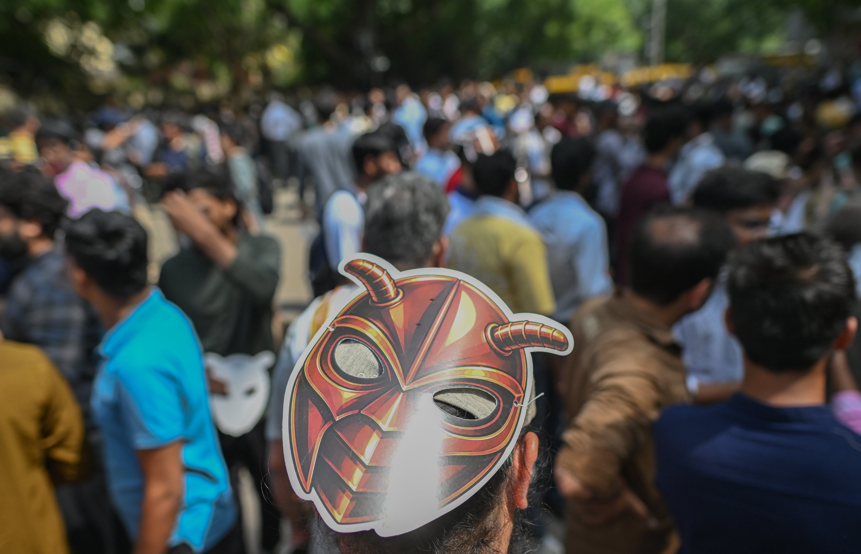 A supporter of CJP wears a cockroach mask during a protest demanding the resignation of the Education Minister over alleged examination paper leaks
