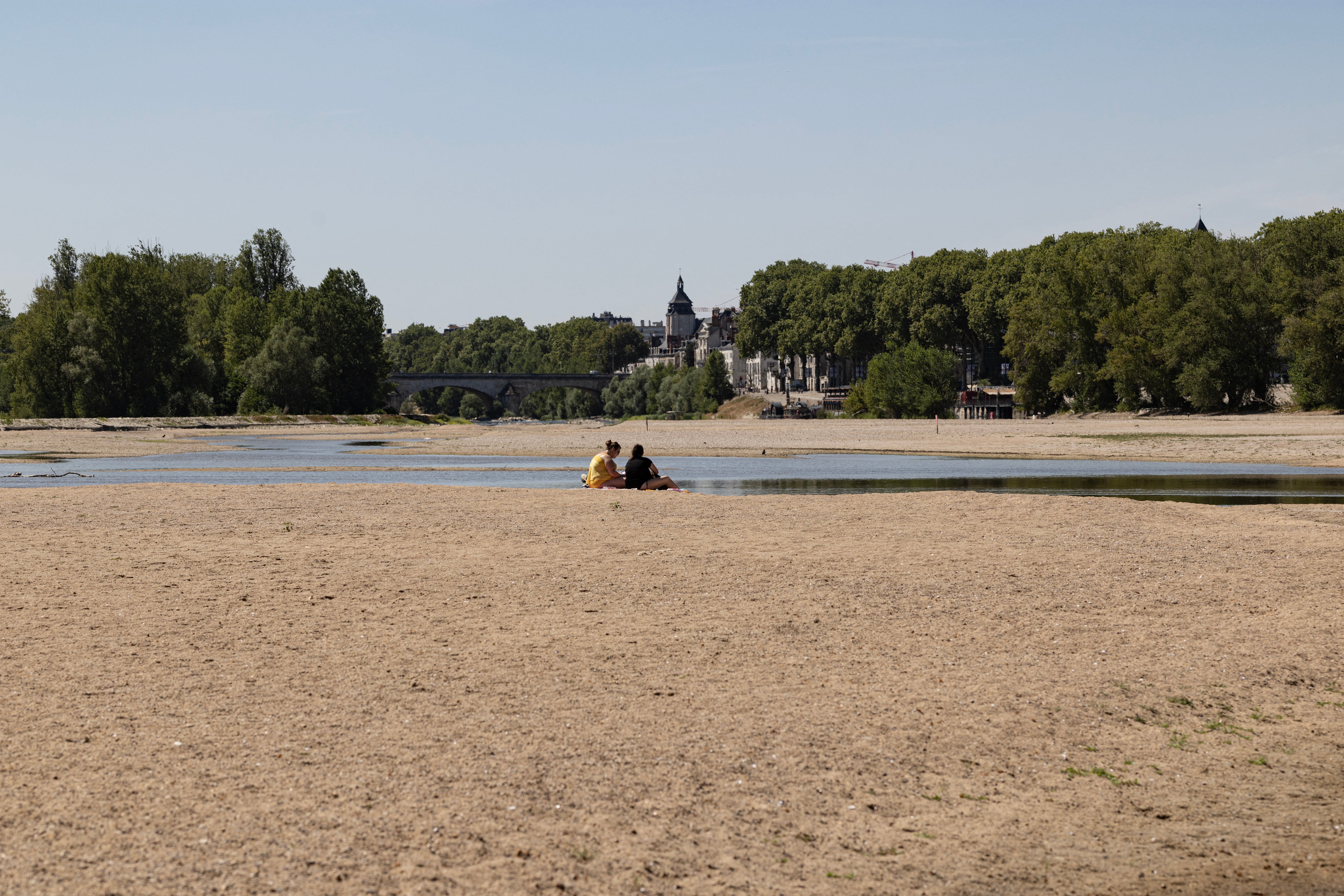 People enjoy the sun on the partially dry Loire riverbed (AFP/Getty)