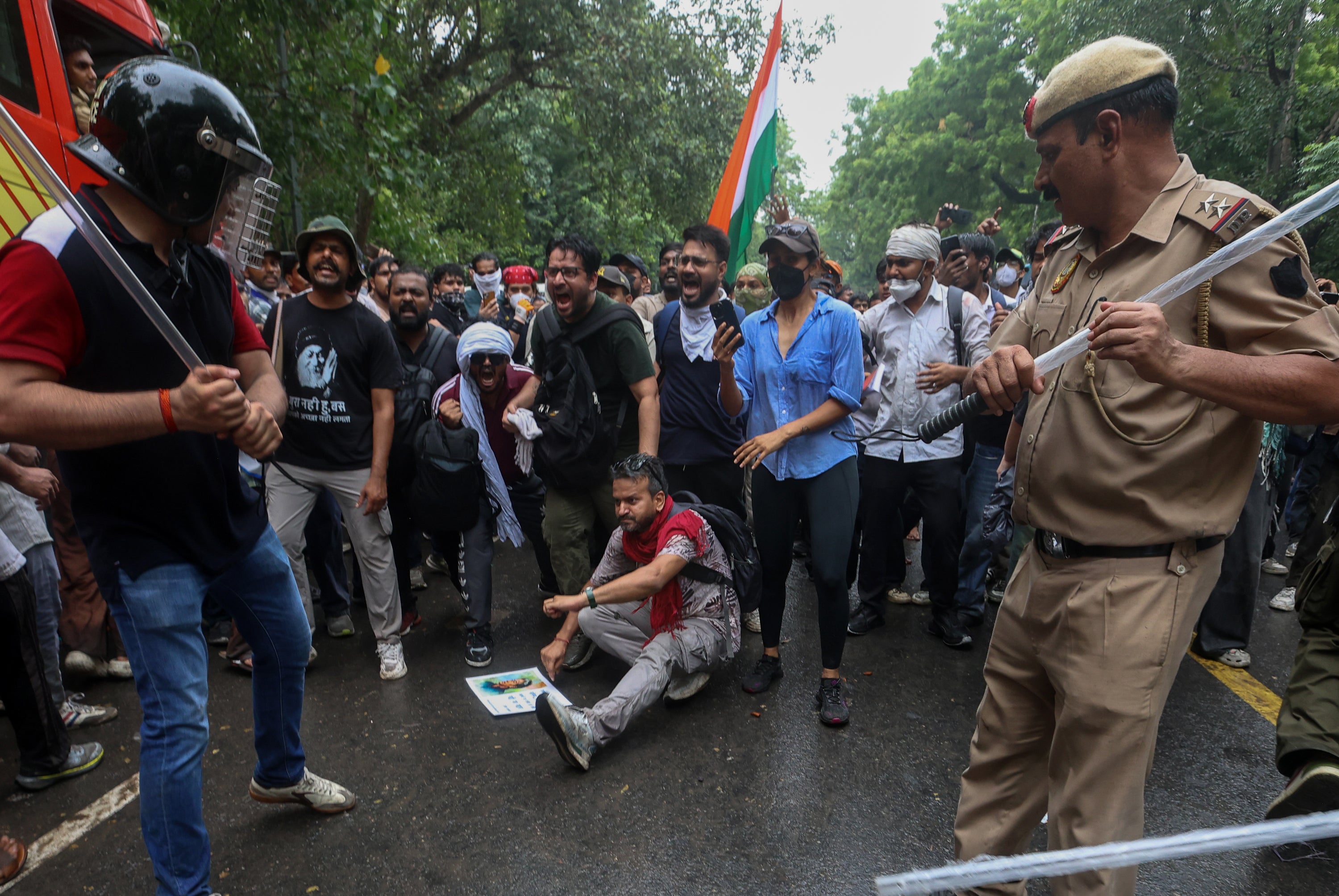 Delhi police officers armed with batons confront protesters during a march organised by CJP on July 20