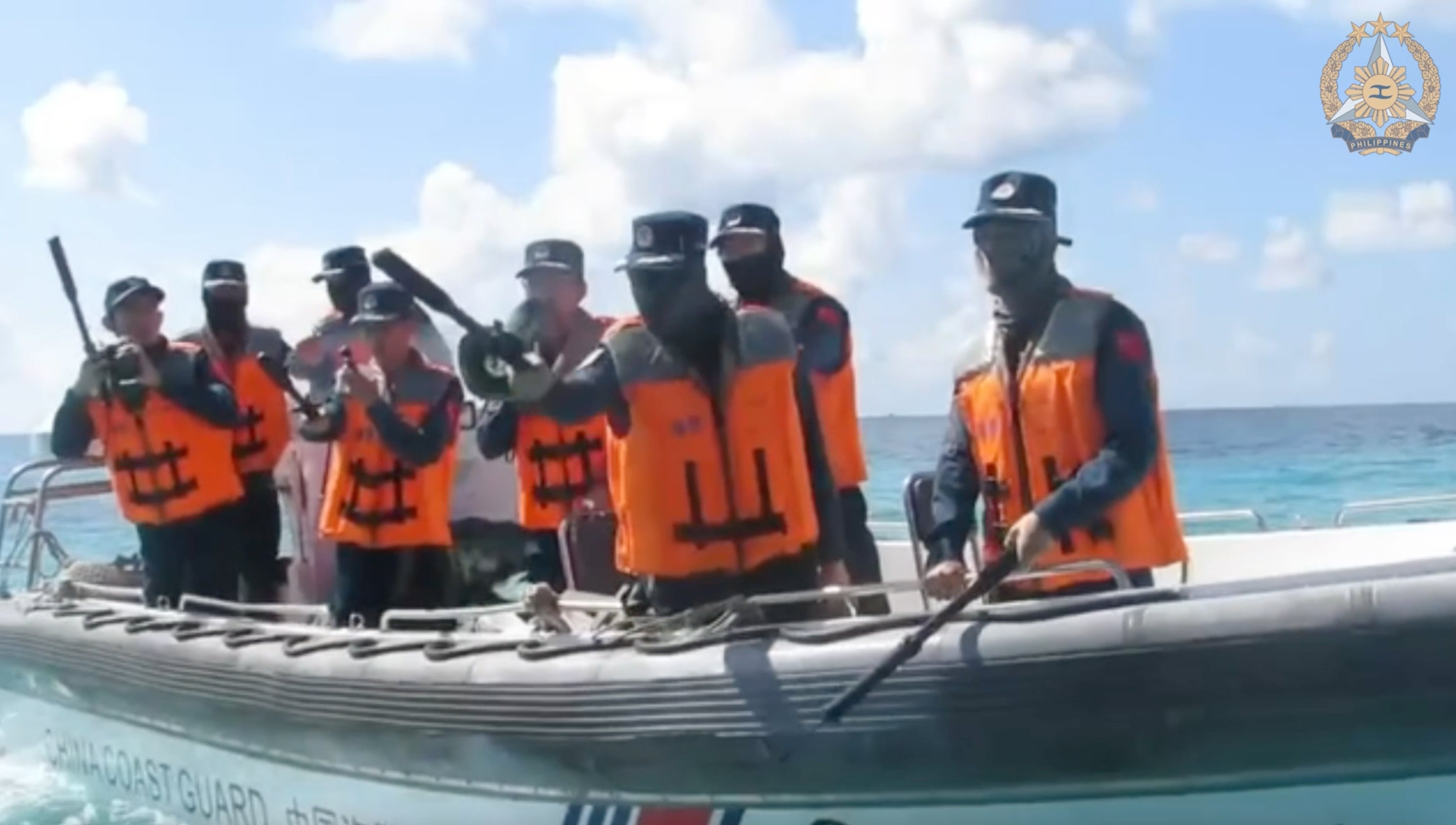 In this photo taken from video from the Armed Forces of the Philippines, China Coast Guard personnel, left, on rigid hull inflatable boat confronts Philippine Navy personnel