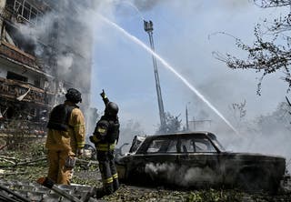 Rescuers work at a site of an apartment building hit by Russian air strike, amid Russia's attack on Ukraine, in Zaporizhzhia